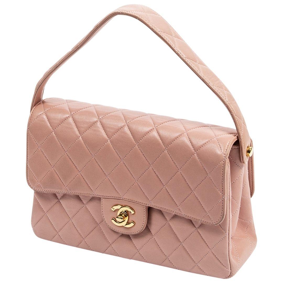 ICONIC! ICONIC! Double sided 1996 Chanel detailed in blush pink diamond quilted lambskin leather, goldtone hardware, a quilted lambskin top handle, with gold plated CC turnlock closures on both sides opening to a leather lining with one slip pocket