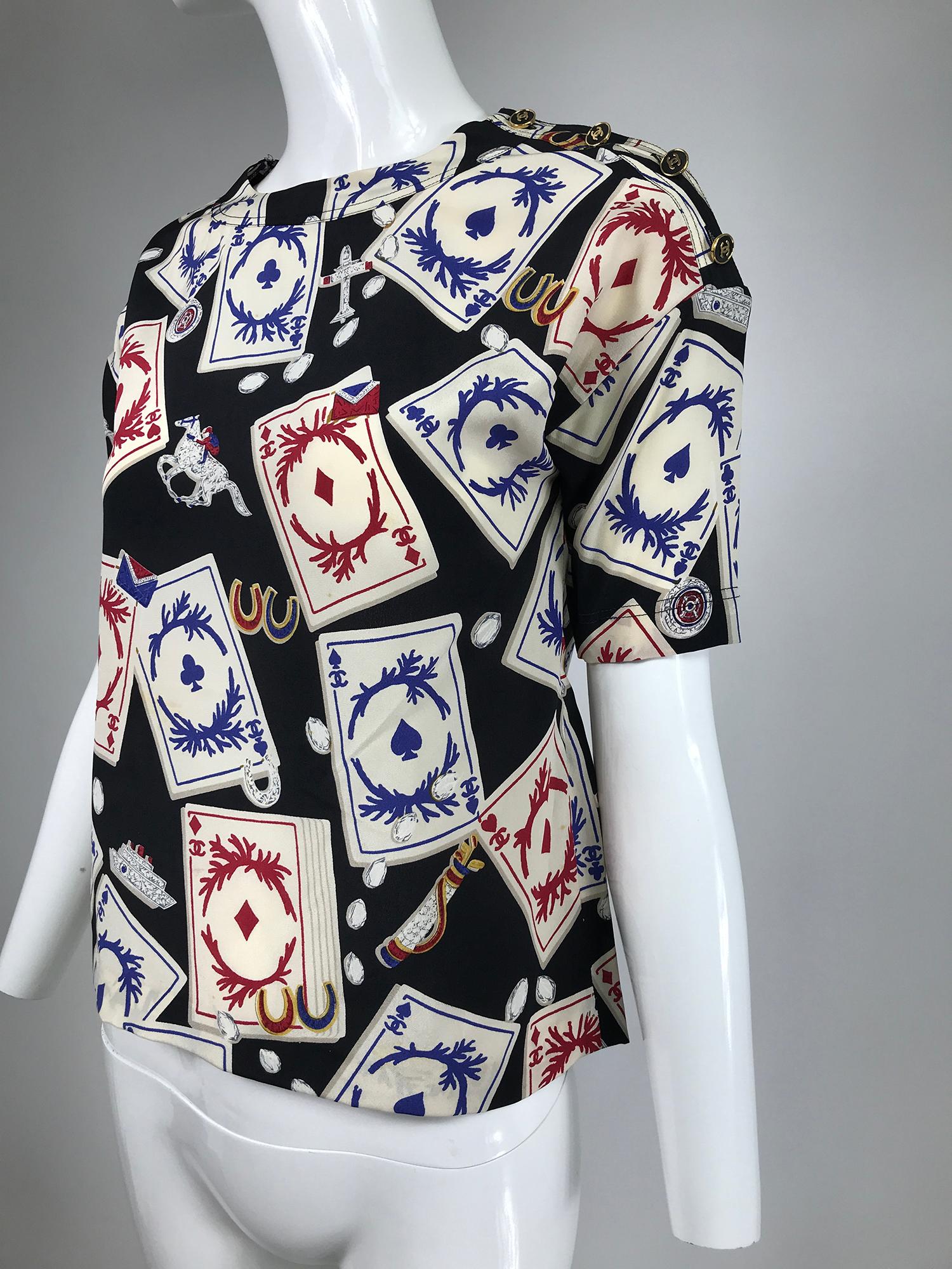 Chanel rare vintage playing cards silk blouse 1995. Jewel neckline blouse closes at the shoulder side with Chanel buttons, short sleeves, slim straight cut to hem. In very good pre owned condition, this blouse has been custom fitted for the previous