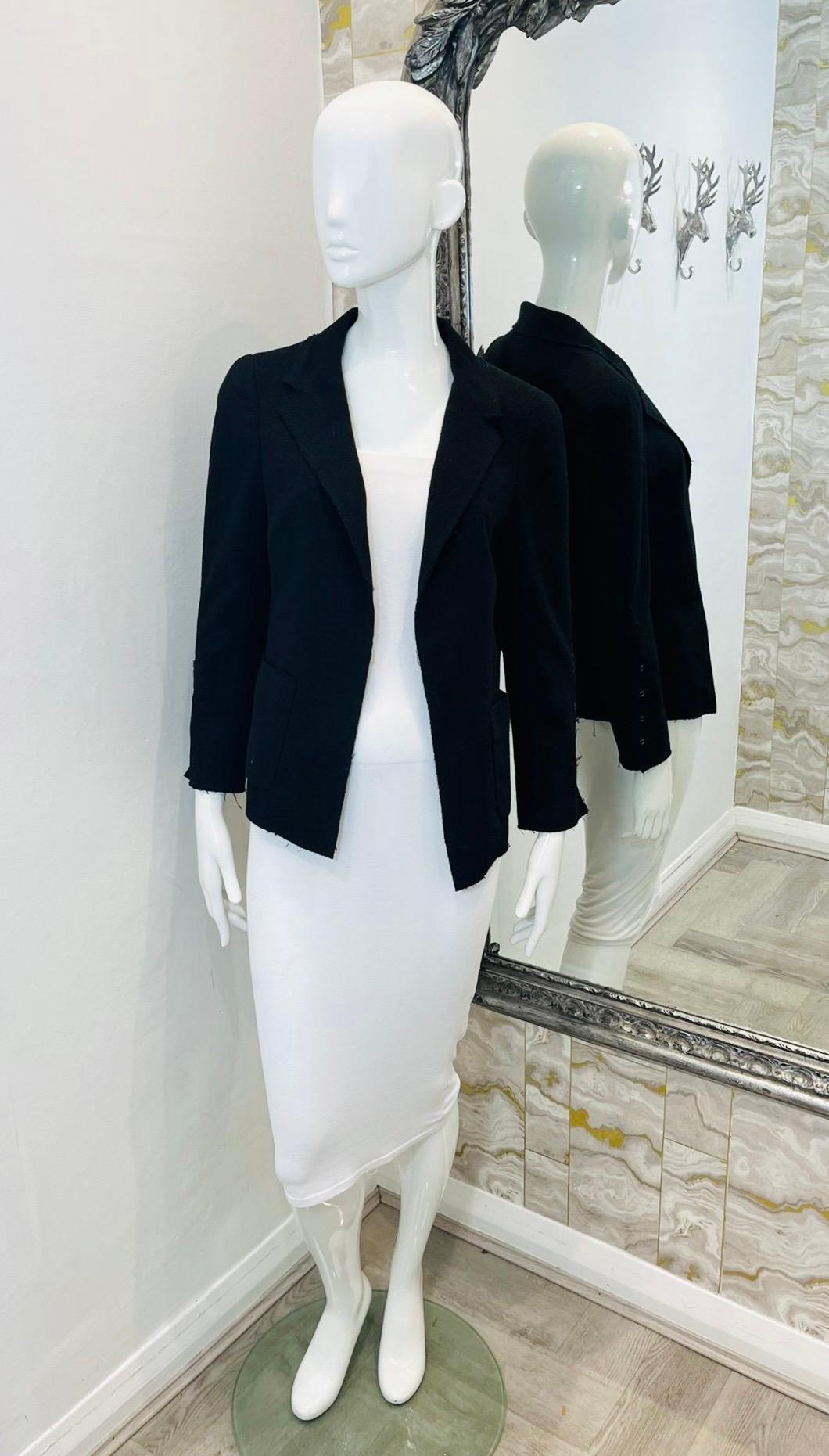 Chanel Raw-Edge Wool Jacket

Black, open jacket designed with 'Chanel Paris' inscribed buttoned cuffs.

Detailed with notched lapels, patch pockets to the sides and silk lining.

From 2007 Spring Collection.

Size – 38FR

Condition – Very