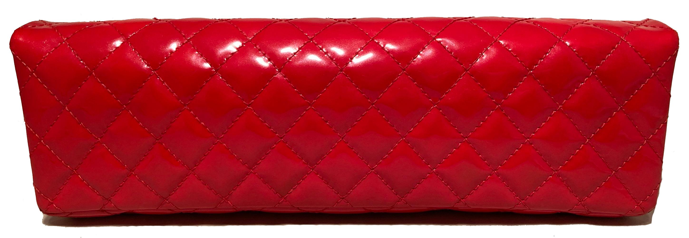 Chanel Red 2.55 Reissue Quilted Patent Leather East/West Clutch in excellent condition. Quilted red patent leather exterior trimmed with gold hardware. Front mademoiselle twist closure opens via single flap to a red leather lined interior with