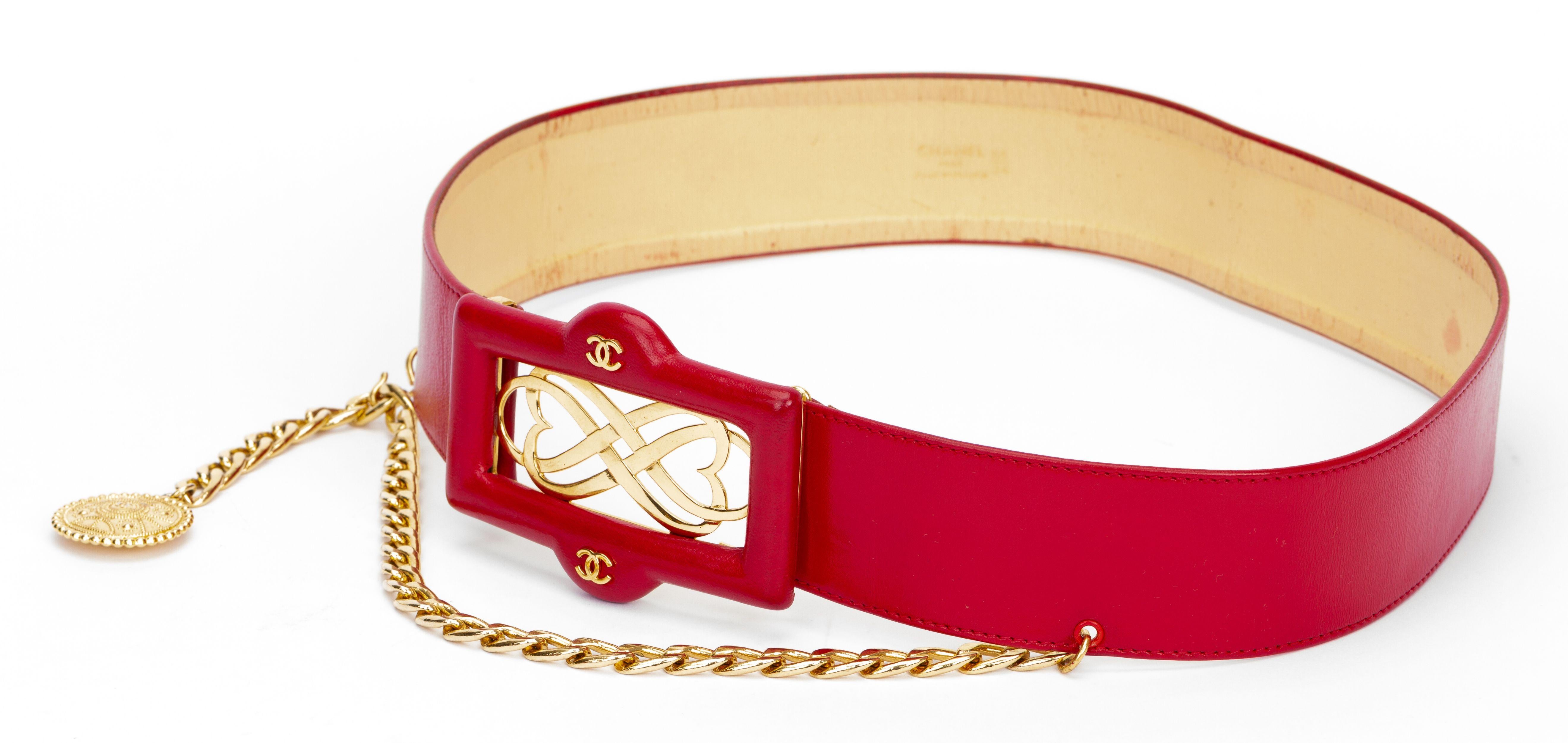 Chanel excellent condition 80s red leather belt with logo buckle, chain drop with coin. Rare large size 85cm/34”. Chain length 15