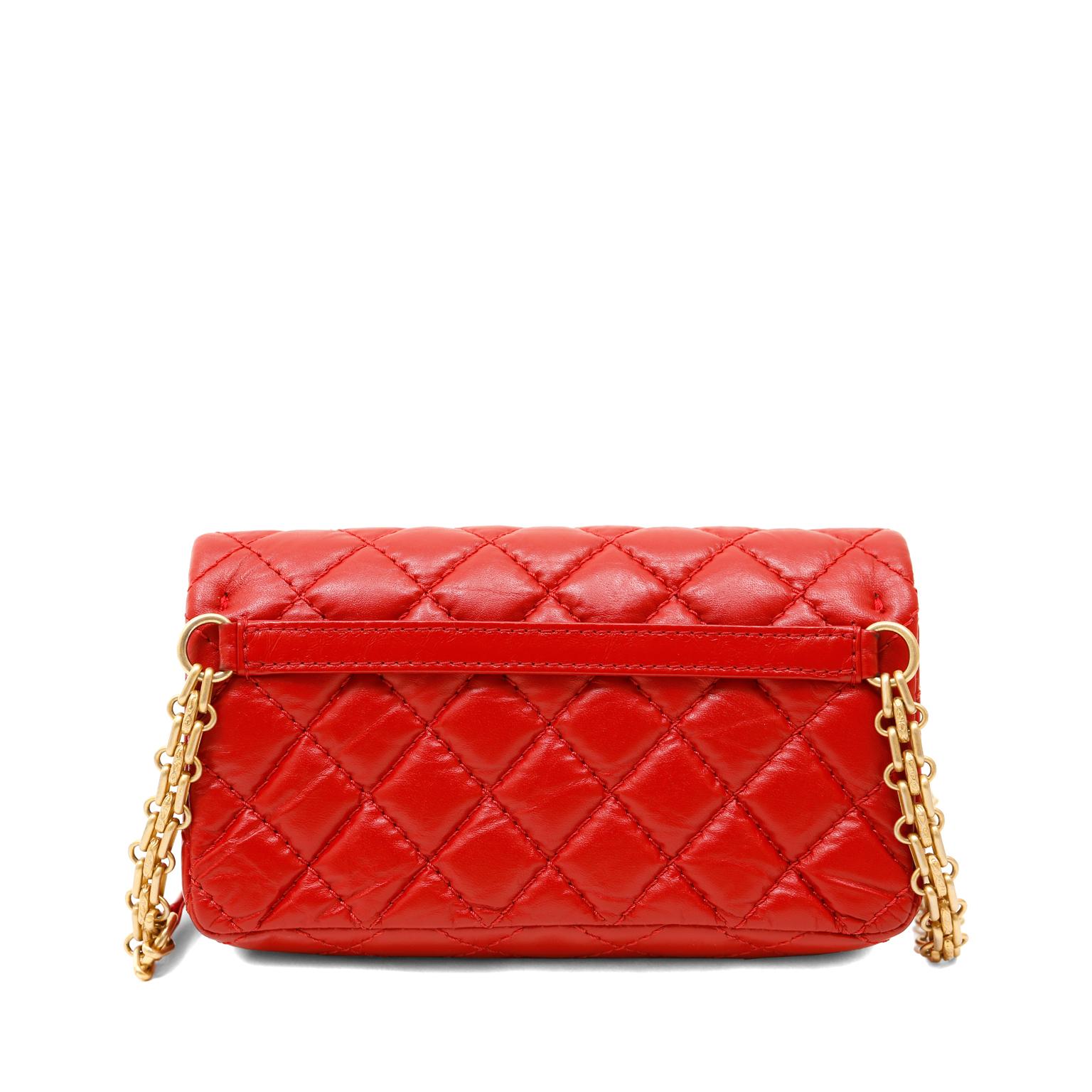 This authentic Chanel Red Aged Calfskin 2.55 Reissue Waist Bag is in pristine condition.  The petite silhouette packs a punch of style into any ensemble.
Lipstick red aged calfskin is quilted in signature Chanel diamond pattern.  Matte gold