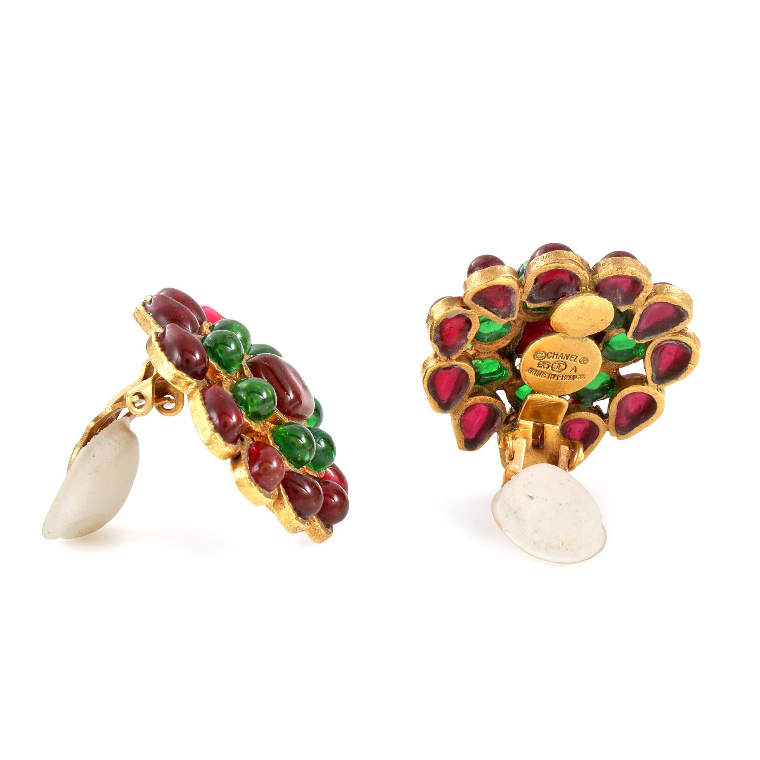 These authentic Chanel Red and Green Gripoix Cluster Earrings are in excellent condition from the Fall 1995 collection.  Red and green Gripoix glass stones form a clustered flower shape.  Set in gold tone metal with clip on closure.  
Made in