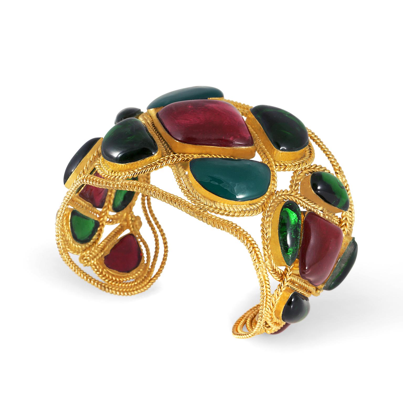 This authentic Chanel Red and Green Gripoix Cuff is in excellent vintage condition from the mid to late 1980’s.  Considered extremely rare, this bracelet is a must have for collectors. 
Red and green glass Gripoix stones are set in ornately twisted