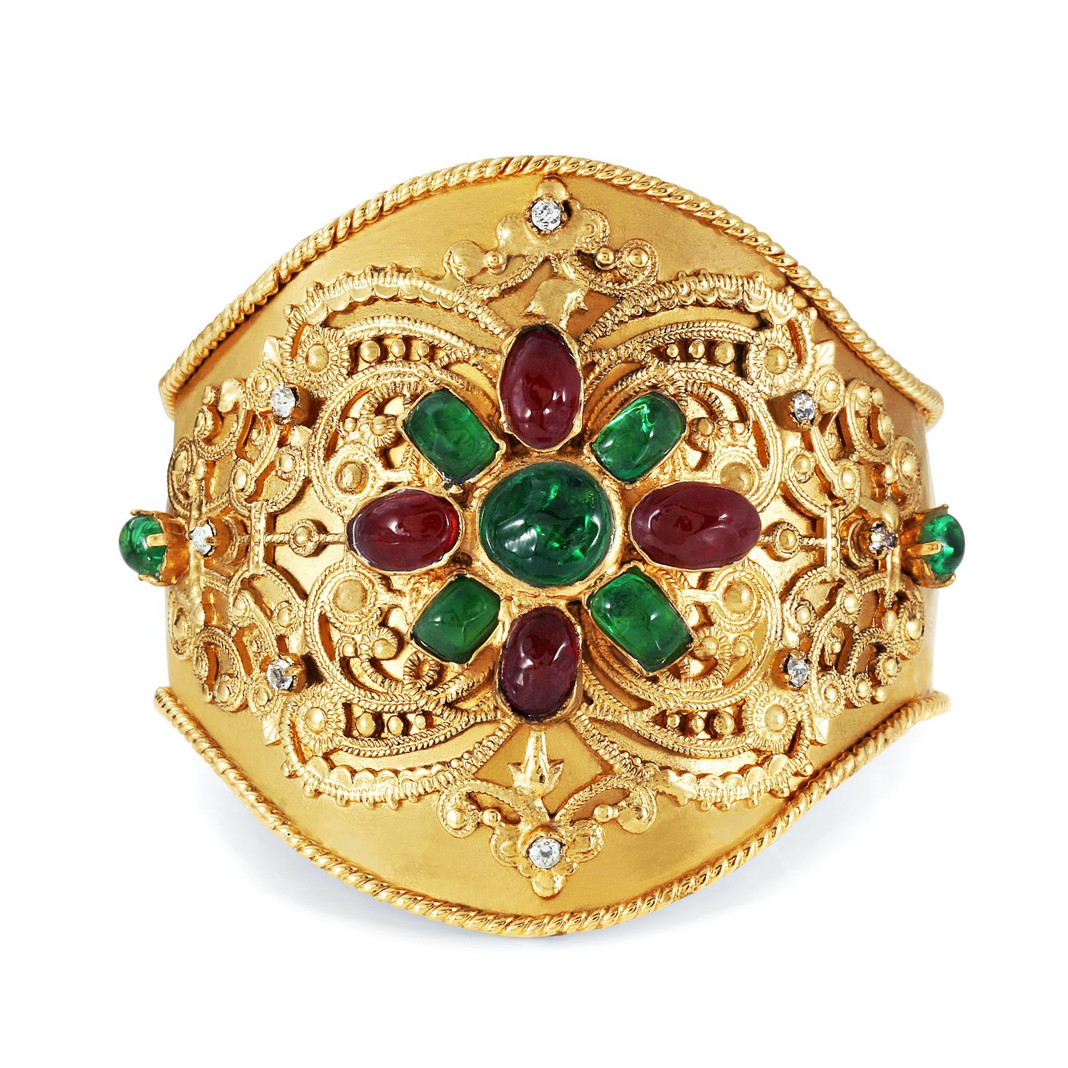 This authentic Chanel Gold Gripoix Cuff is in excellent vintage condition form the 1970’s.  Very rare and collectible, it features dark red and green Gripoix stones in a floral design on an ornately detailed gold cuff.  Made in France.
