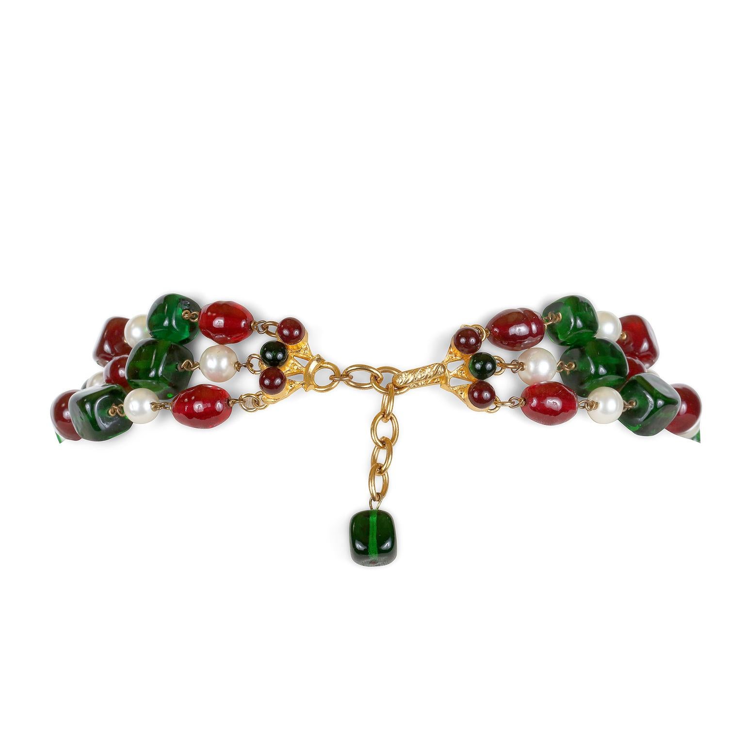 This authentic Chanel Red and Green Gripoix Triple Strand Necklace is in excellent condition from the Fall 1993 collection.  Festively designed in vibrant red and green Gripoix glass beads and interspersed with faux pearls.  Two beaded tassels