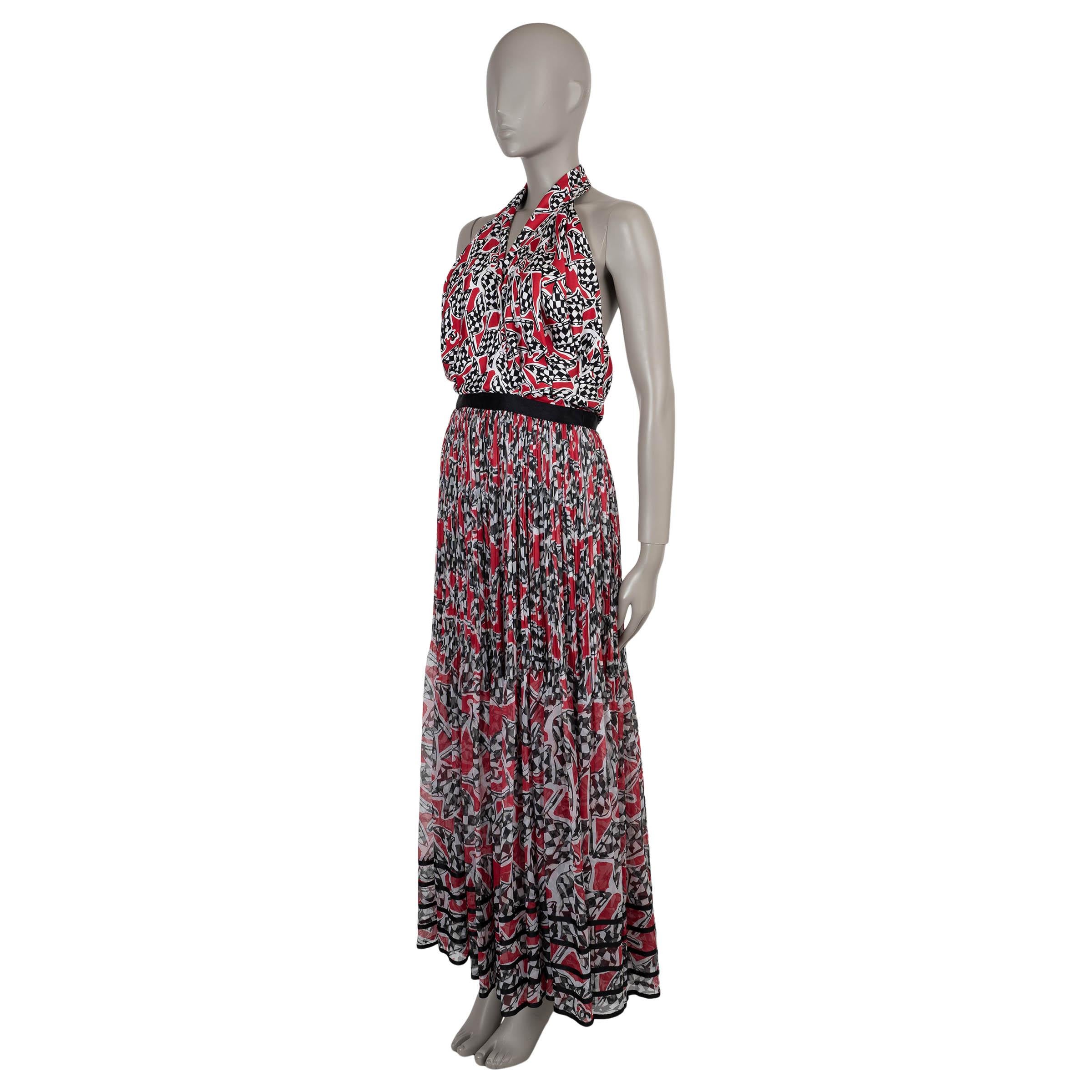This 100% authentic Chanel gown in red, black, white, and beige race flag printed chiffon silk embodies bold sophistication. Designed with a fit and flare silhouette and maxi length, it features a crossed halter neck and black velvet ribbons