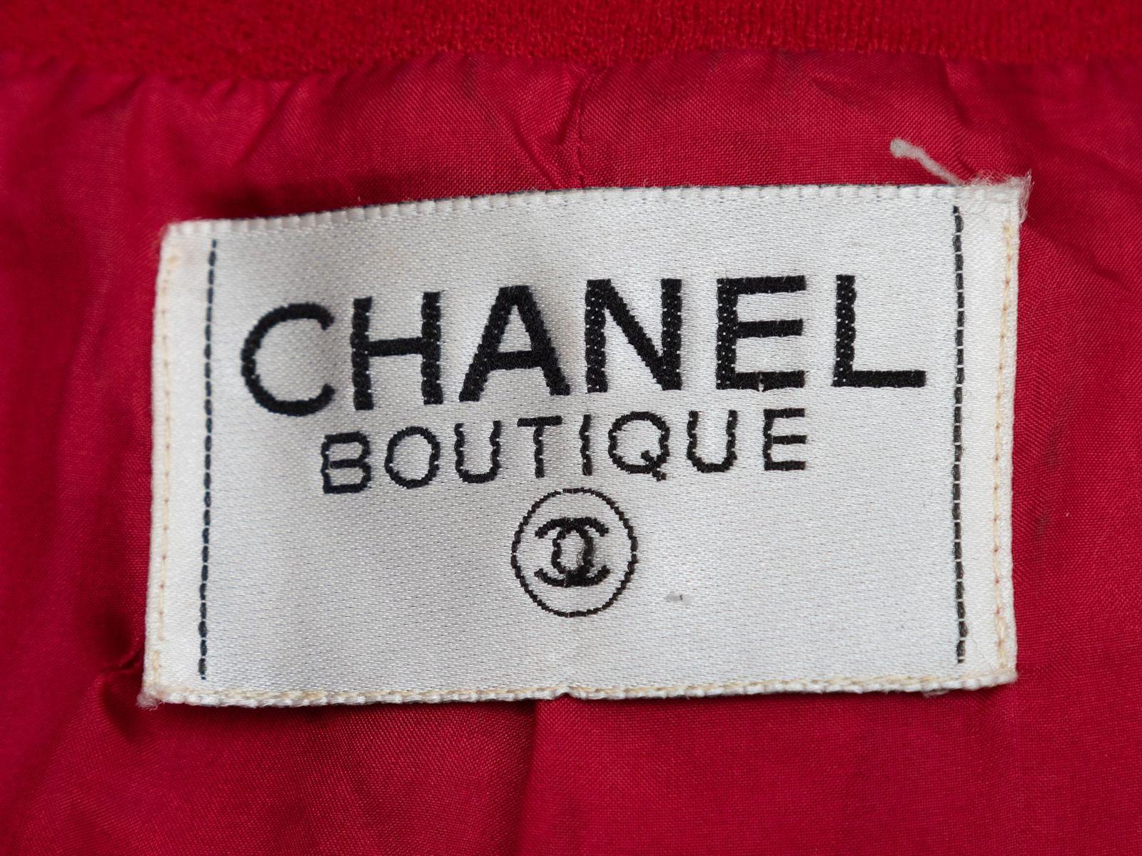 Product Details: Vintage red wool jacket by Chanel Boutique. V-neck. Four pockets. Gold-tone button closures at center front. 44