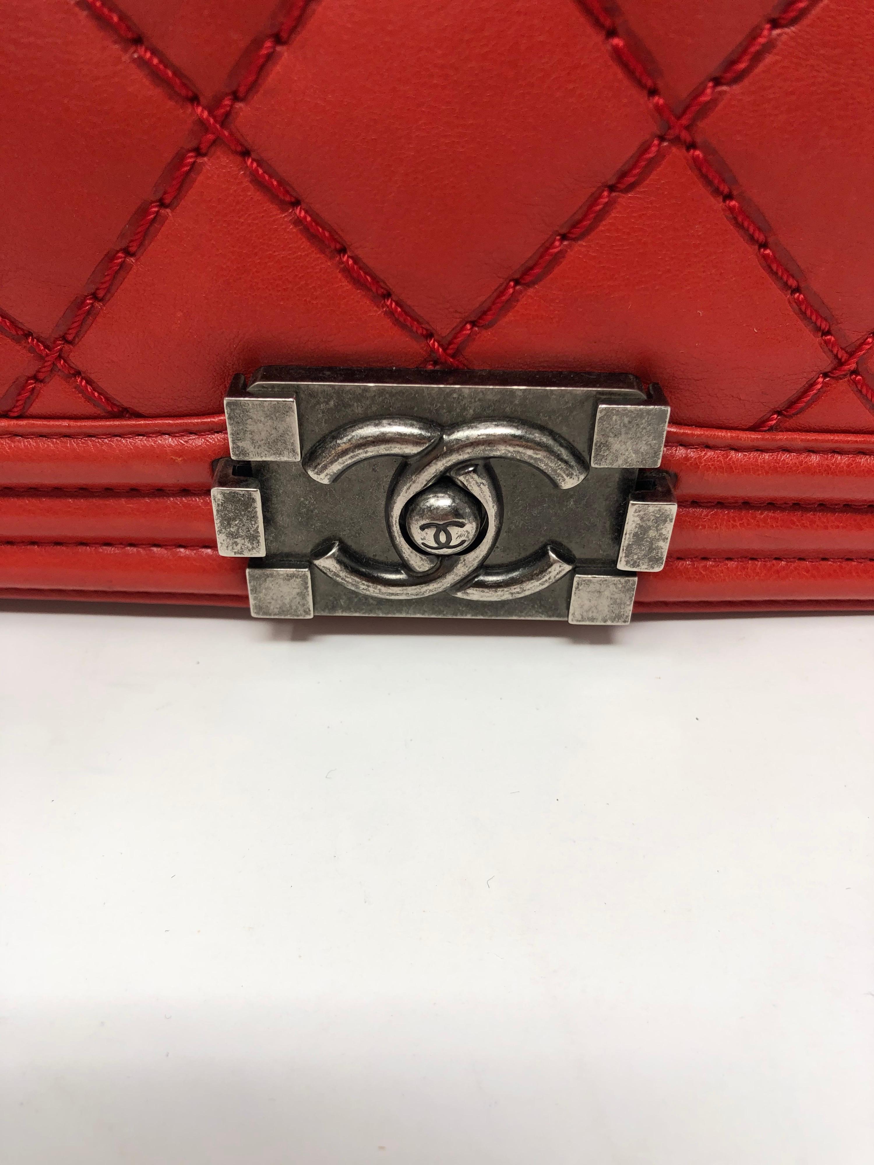 Chanel Red Boy Bag. Medium size. Mint condition. Bright red leather with antique silver hardware. Guaranteed authentic. 