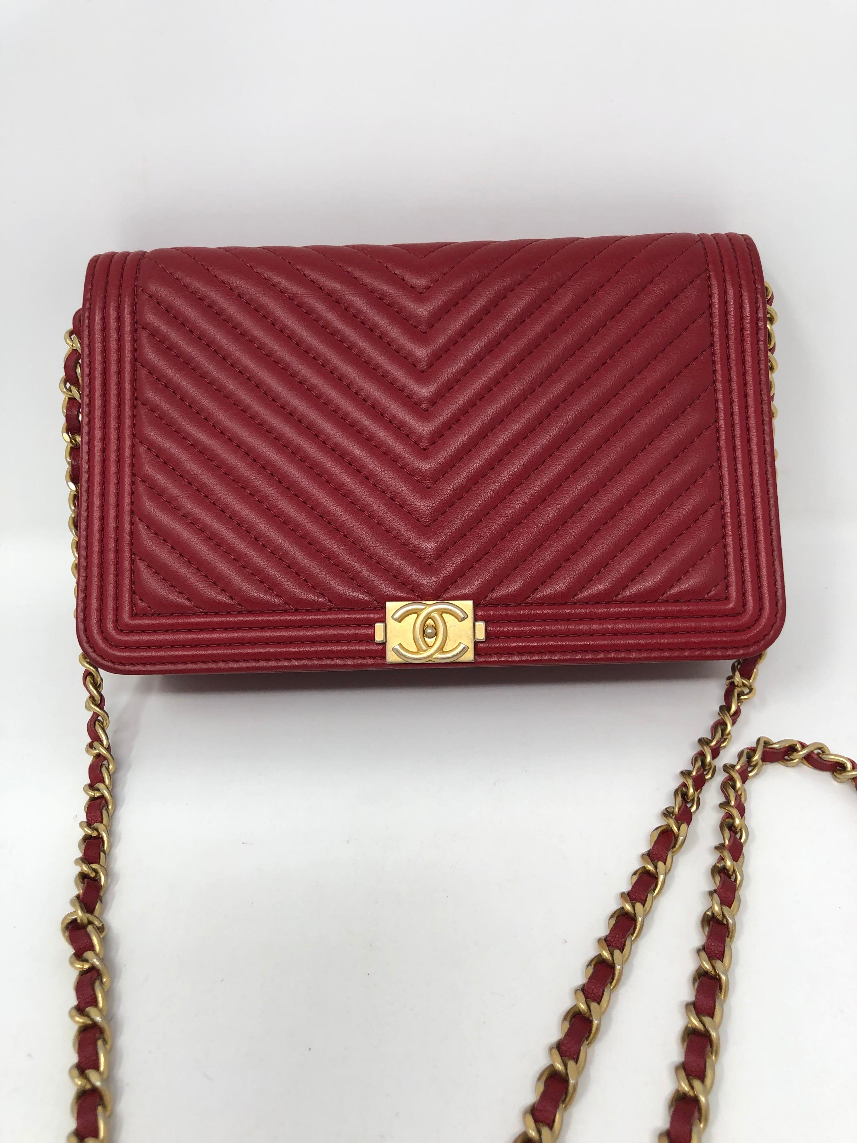 Chanel Red Boy Wallet On A Chain Bag. Gold hardware. Excellent condition. Crossbody or clutch. Chevron pattern. Guaranteed authentic. Includes dust cover 