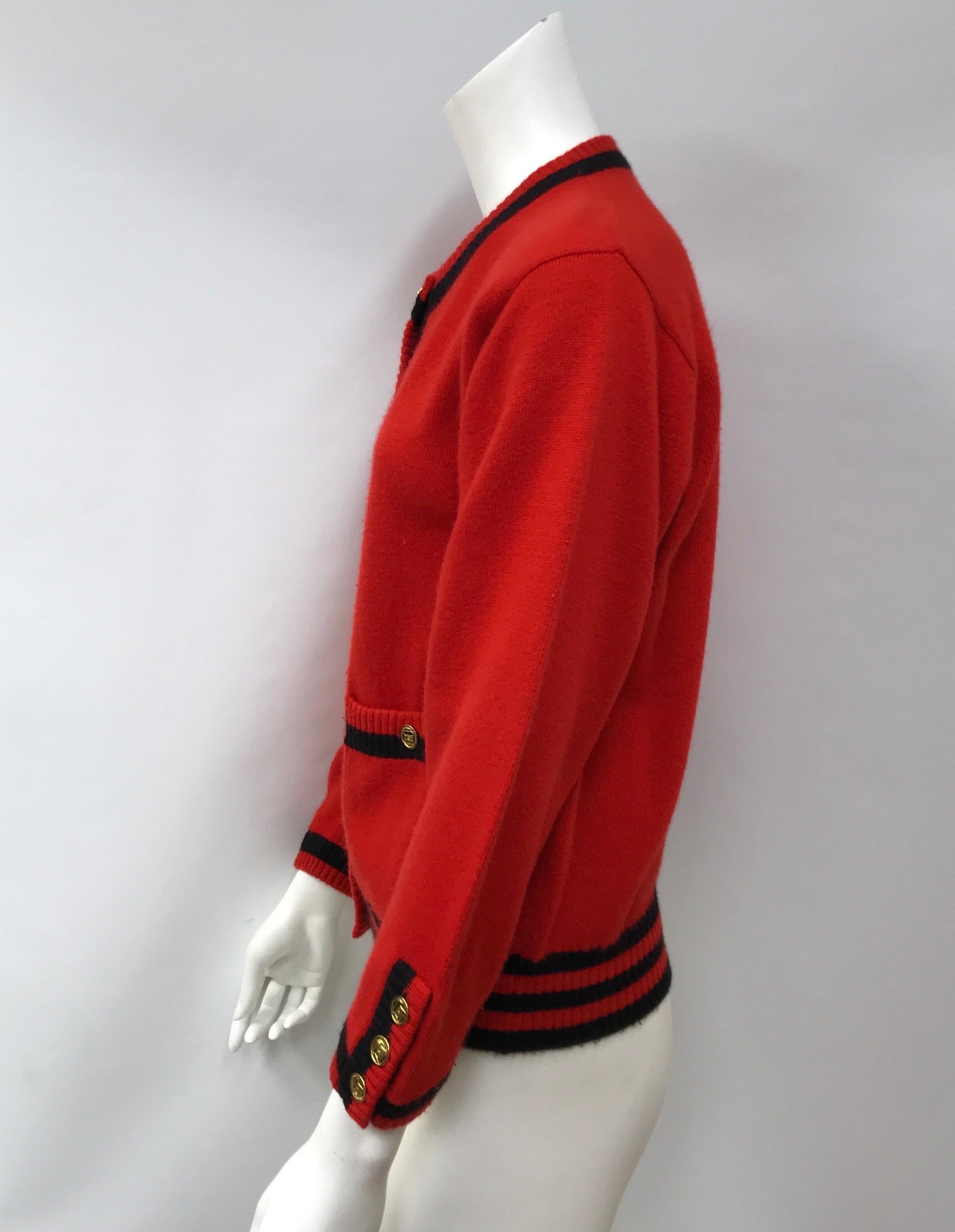 Chanel Red Cashmere Cardigan w/ Navy Trim-44. This beautiful Chanel cardigan is in excellent condition. There is no sign of use, may need a little shaving. It is made of 100% cashmere and is red throughout with navy trim. There are gold buttons on