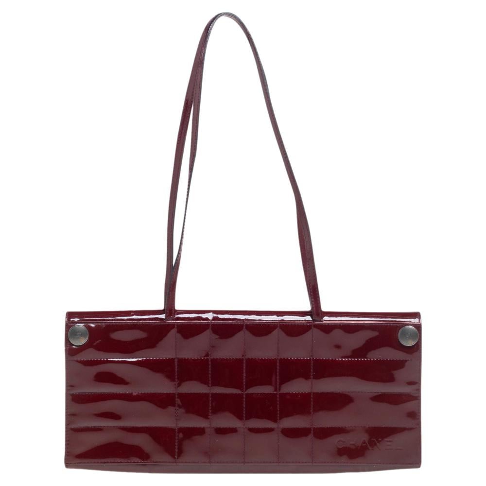 A bag to complement both Chanel lovers and handbag admirers is this one. It is made from patent leather and features a cube quilt on the exterior. The bag is held by slim handles and a satin-lined interior. It looks pretty in a red hue.