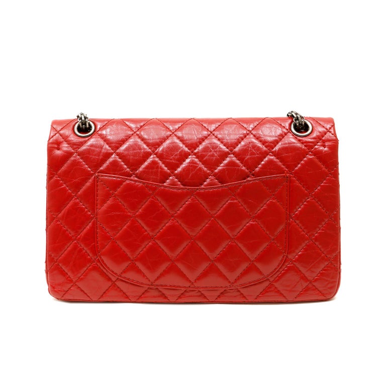 This authentic Chanel Red Distressed Lambskin Reissue Flap Bag is in excellent condition.  The 2.55 variation is a timeless collectible and is strikingly beautiful in lipstick red with ruthenium hardware, 226 silhouette.
Intentionally distressed red