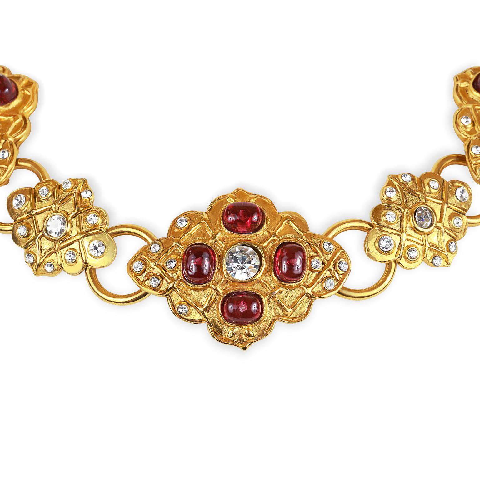 This authentic Chanel Red Gripoix and Crystal Choker is in excellent vintage condition.  Extremely rare, this is an early Chanel design.  
Gold medallions adorned with red Gripoix glass stones and crystals are connected together with smaller