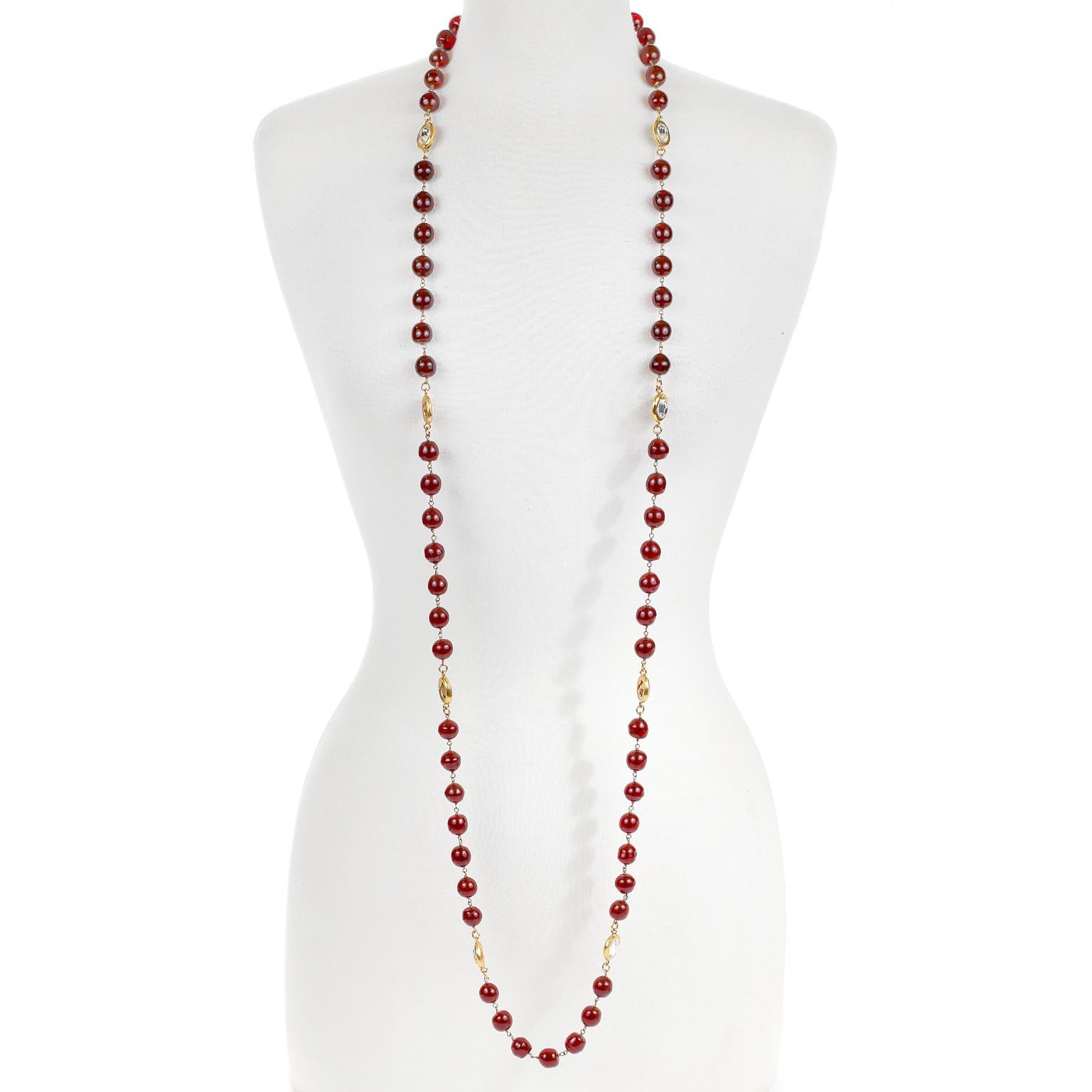 This authentic Chanel Red Gripoix and Crystal Necklace is in excellent vintage condition.  Large red Gripoix glass stones have rose cut crystals stations.  Gold tone metal.    Measures 60 inches.  Can be worn single or double.  Spring hook clasp.