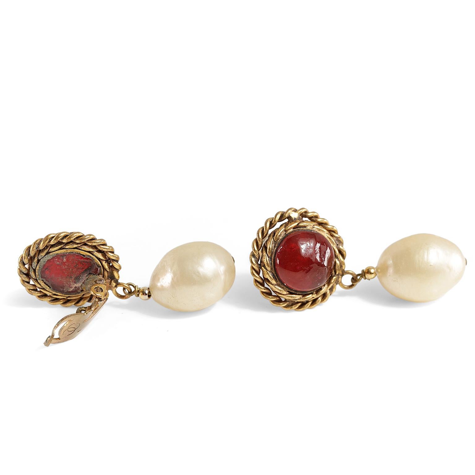 Chanel Red Gripoix and Pearl Clip on Earrings- Excellent Condition  
Baroque pearls dangle from dark red gripoix stone with gold braided surround.  Clip on style.  1980’s.
