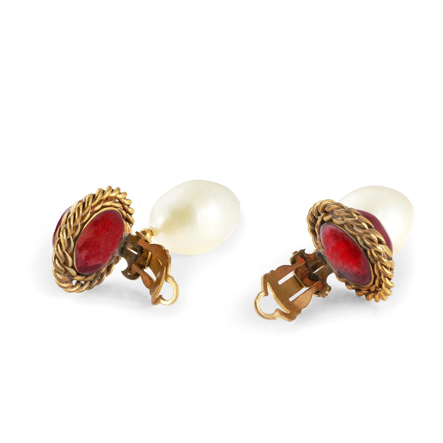 These authentic Chanel   Red Gripoix and Pearl Drop Earrings are in beautiful condition.  Early Chanel design features a deep red Gripoix glass stone with gold chain surround.  A delicate faux pearl dangles from the bottom.  Clip on closure.  Pouch