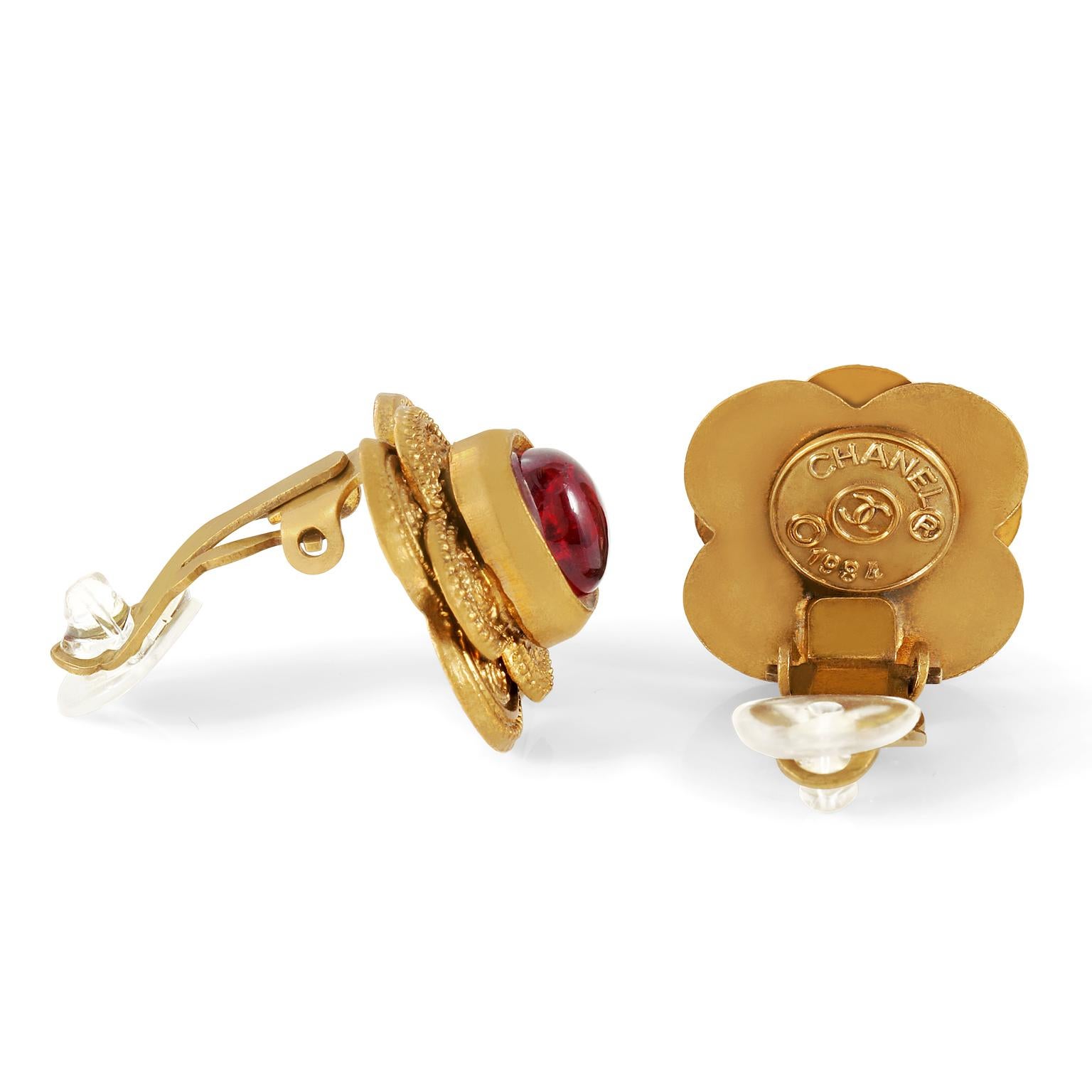 These authentic Chanel Red Gripoix Earrings are in excellent vintage condition from the 1984 collection.  Red Gripoix glass stones are centered on a double layer of gold flower cutouts.  Ornately detailed.  Clip on closure.  Made in France.  Pouch