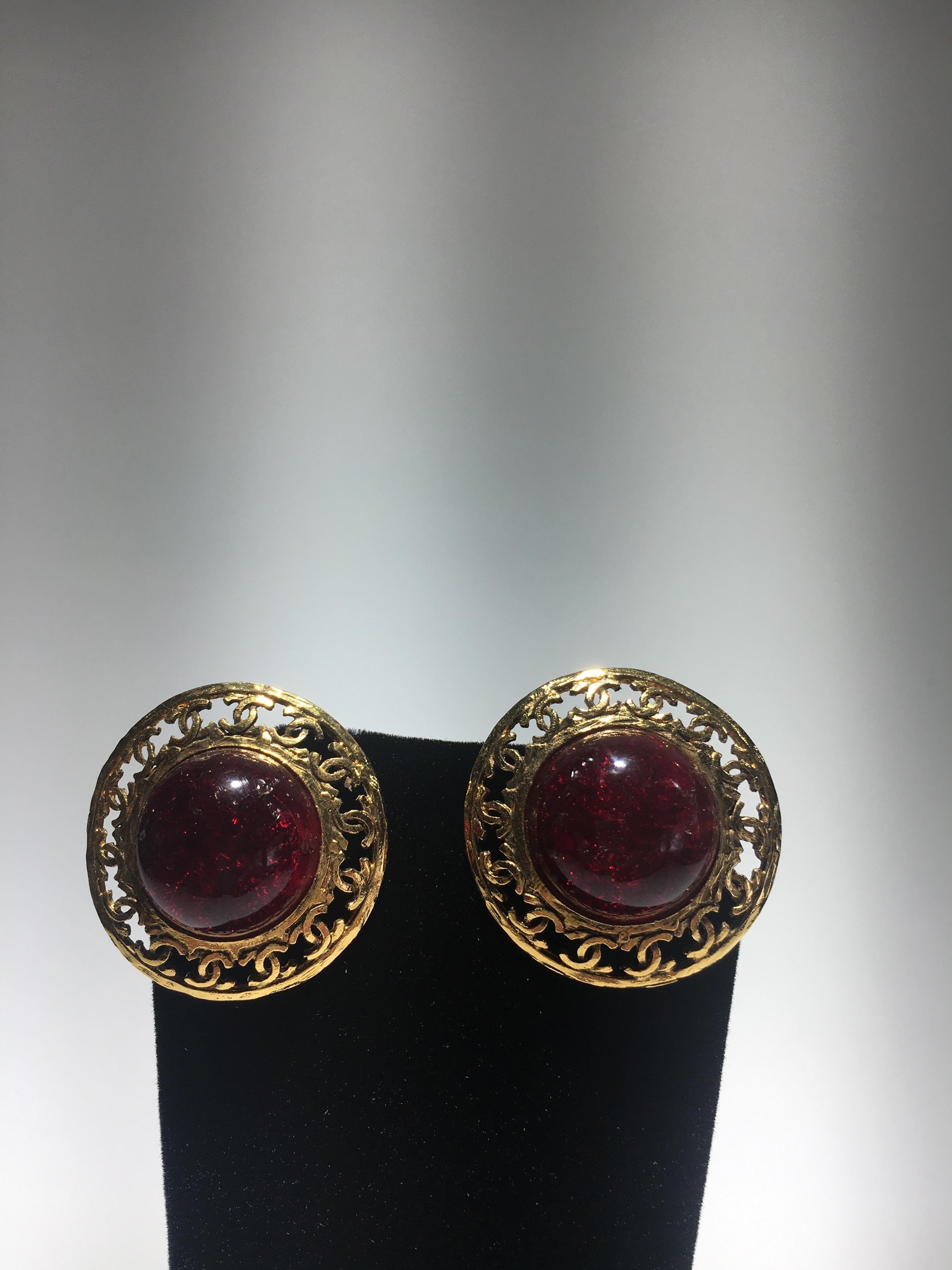 Chanel red poured glass, gripoix, and gold cc metal clip on earrings. They come with original box.  Stones have internal inclusions to appear to be natural stones.
