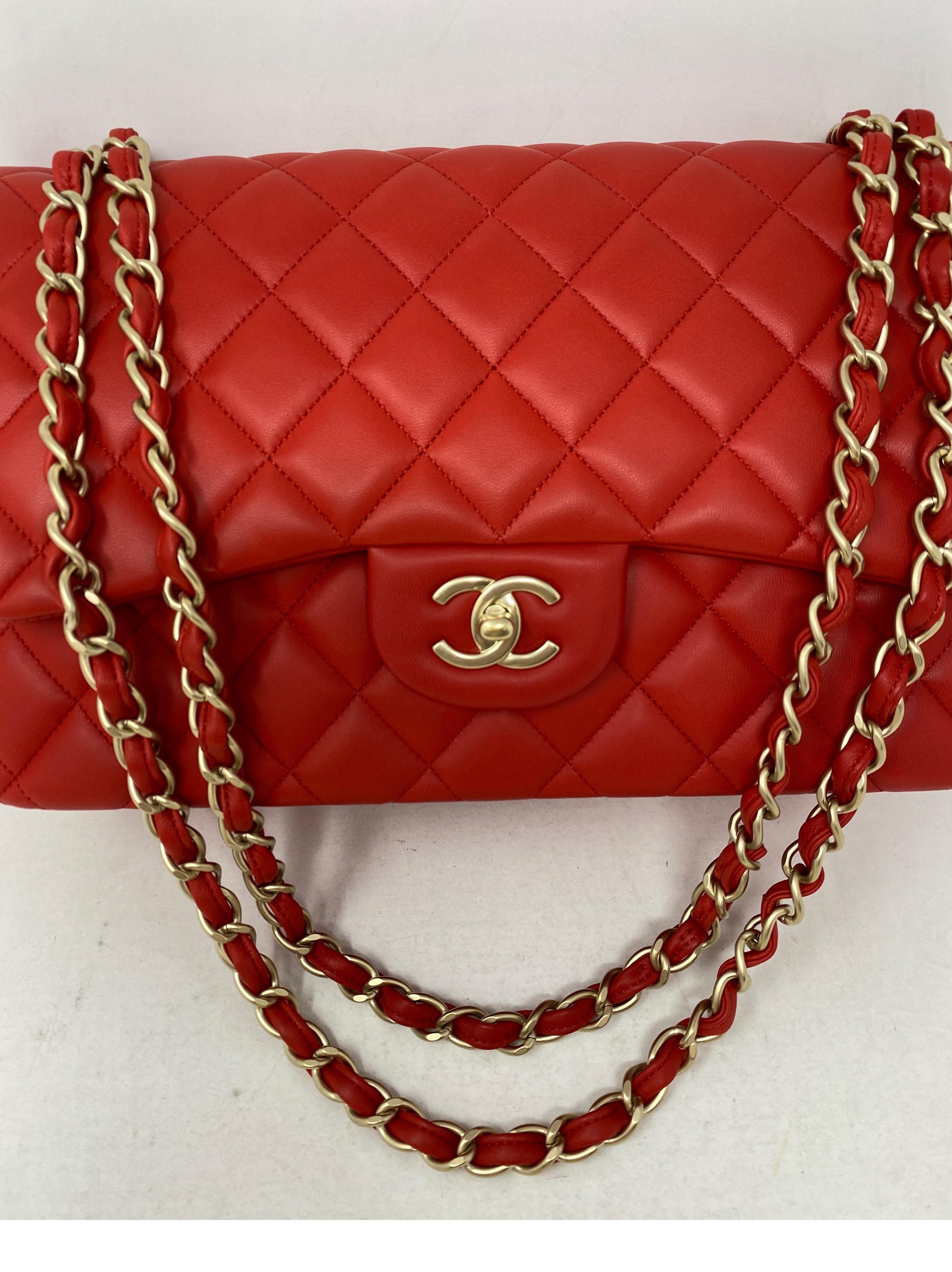 Chanel Red Jumbo Double Flap Bag. Gorgeous bright red lambskin leather. Gold hardware. Double flap bag. Jumbo size bag can be worn crossbody or doubled as a shoulder bag. Rare color combo. Includes authenticity card and dust cover. Guaranteed