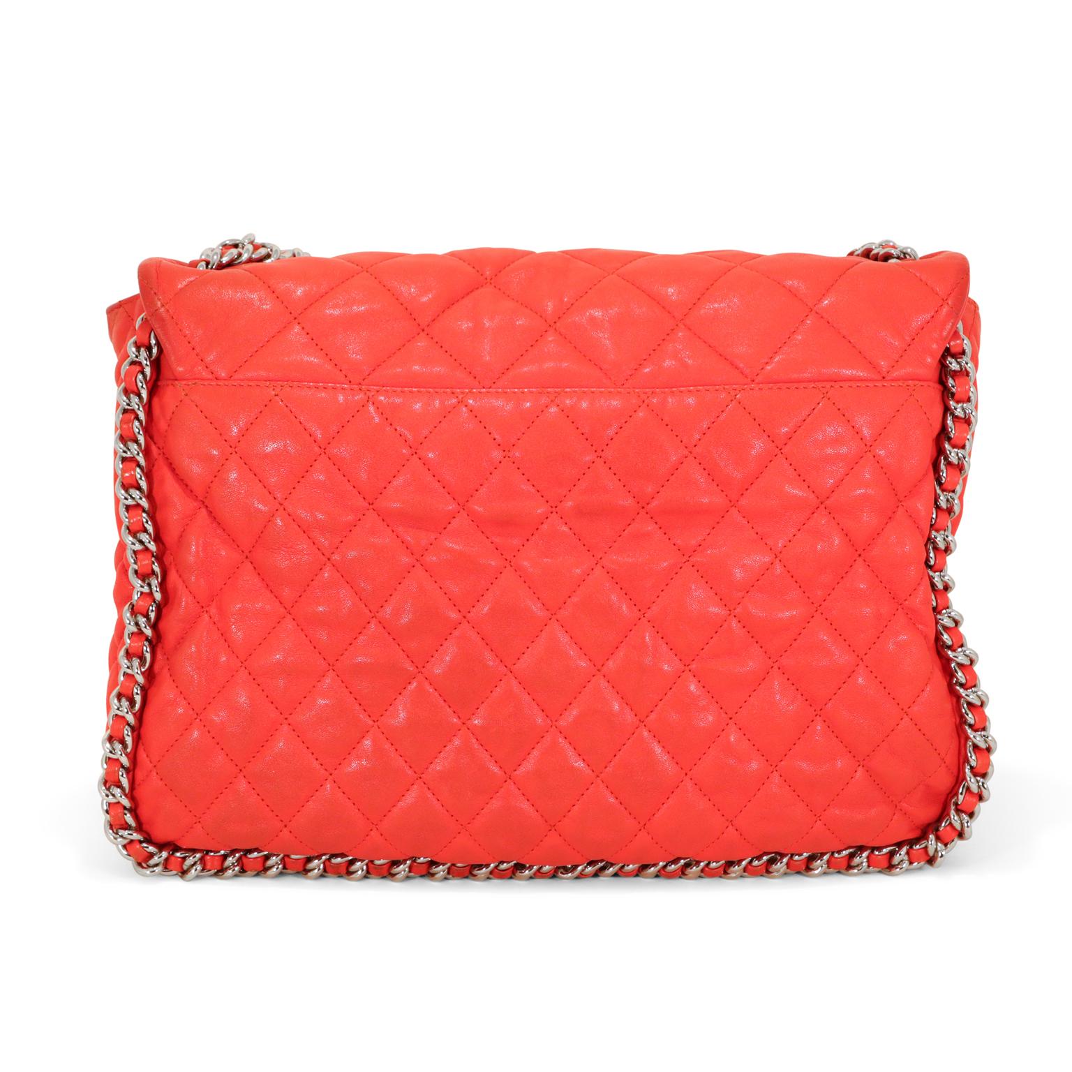 This authentic Chanel Red Lambskin Chain Around Maxi is in very good condition.  It has enjoyed a previous life and therefore may have minor imperfections.
Vibrant red washed lambskin is quilted in signature Chanel diamond pattern.  Silver