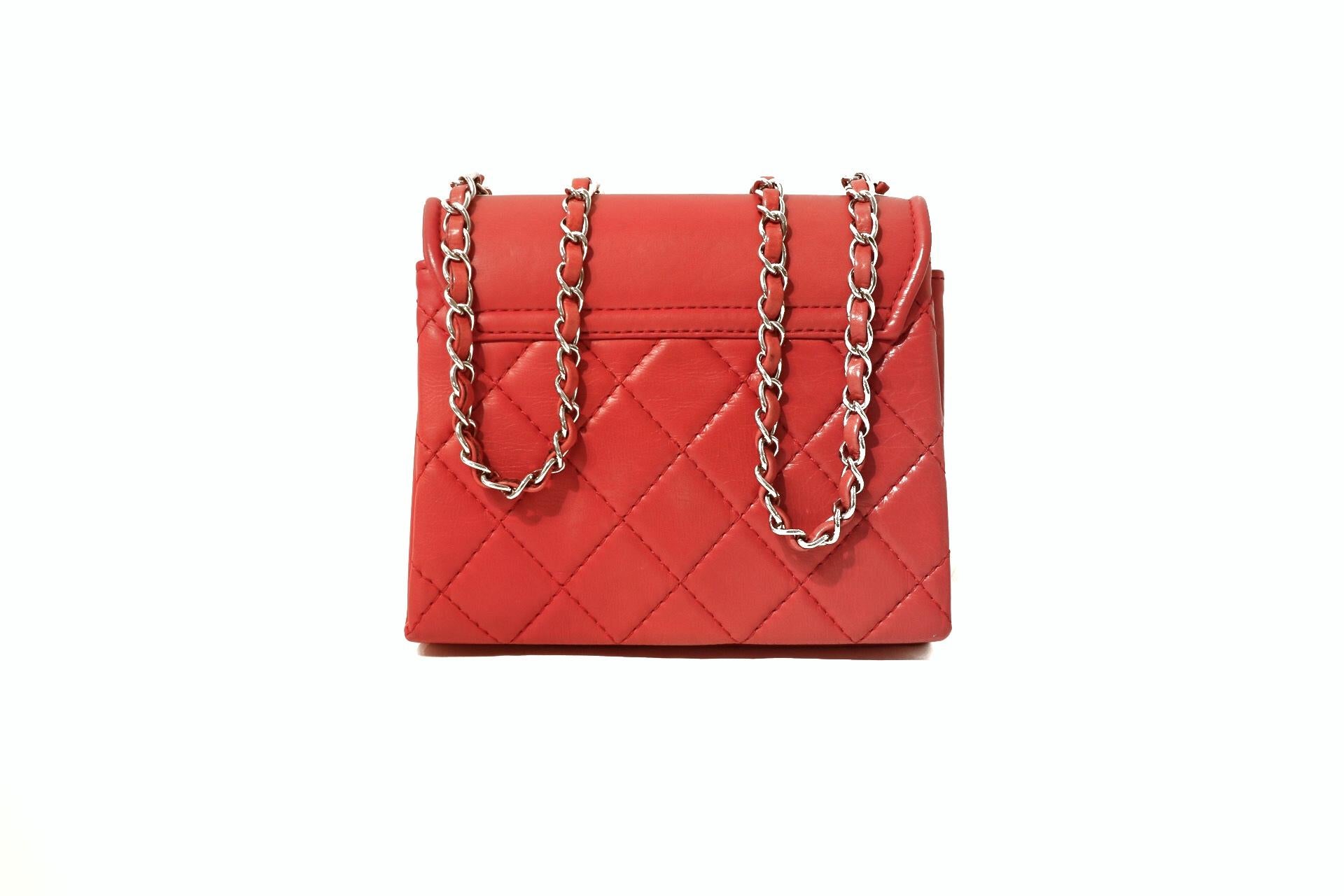 This authentic Chanel Red Leather Double Gusset Flap Bag is in pristine condition.  Small but mighty, the vibrant color and simple design makes this a brilliant addition to any collection. 

Lipstick red lambskin is stitched in signature Chanel