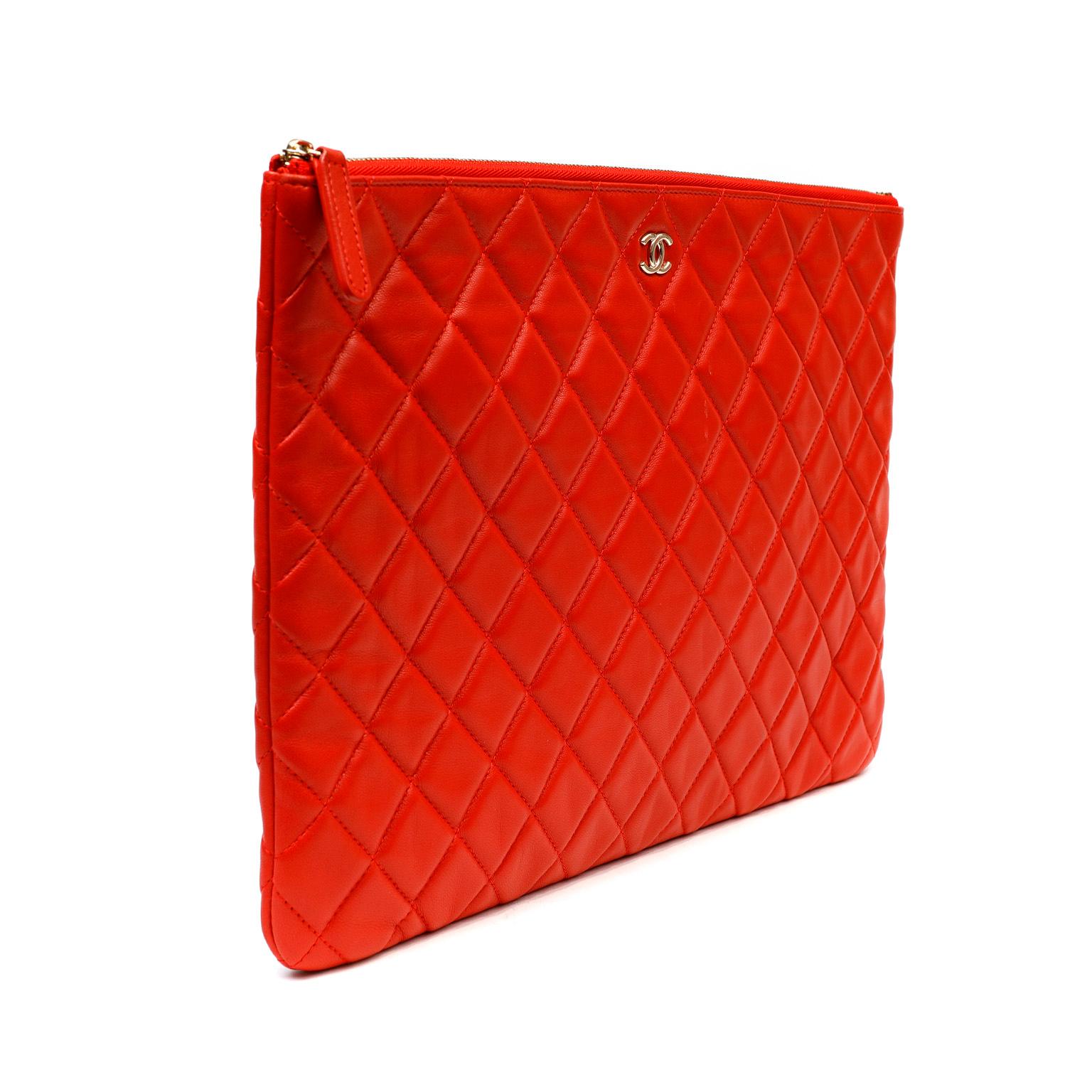 This authentic Chanel Red Lambskin Classic Case is in pristine condition.  Spacious slim zip top case is quilted in signature Chanel diamond pattern.  Silver hardware. Perfect for evening clutch carry or tossing inside a larger bag.  Dust bag