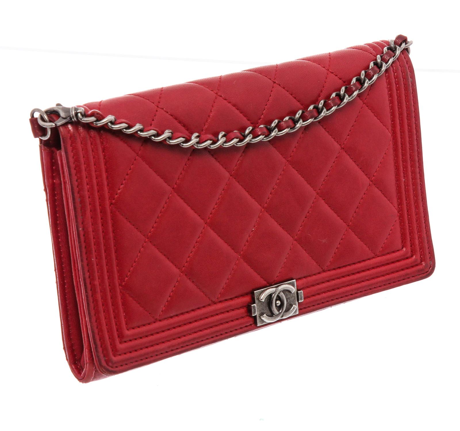 Red diamond-quilted lambskin Chanel Boy Wallet On Chain with antiqued silver-tone hardware, single chain-link and leather shoulder strap, dual interior compartments; one with zip closure, tonal woven interior, three interior wall pockets; one with