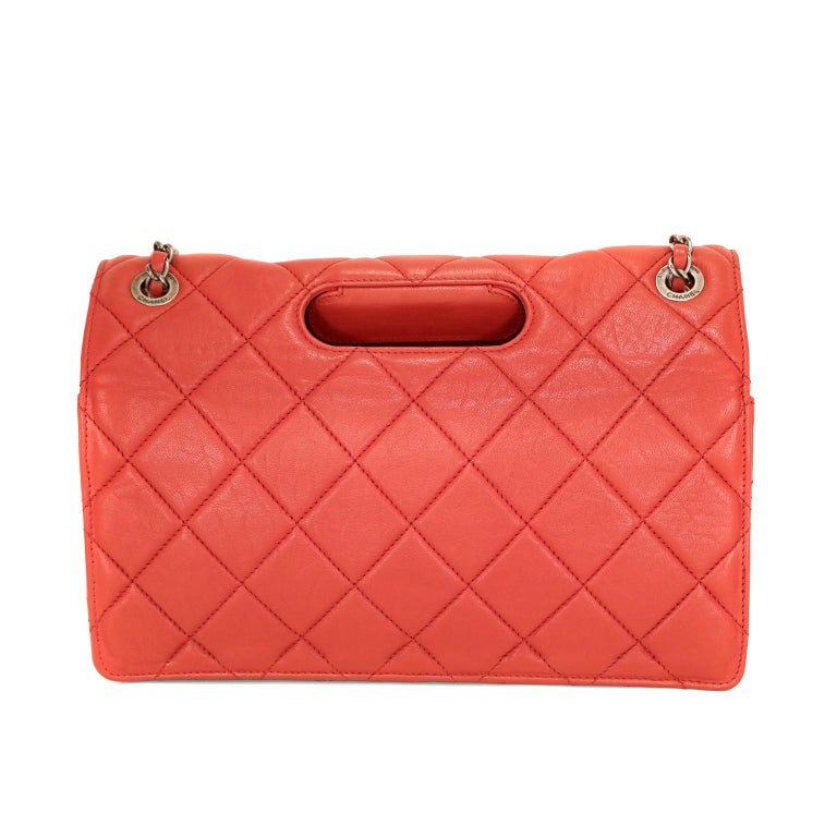 This authentic Chanel Red Lambskin Paris Byzance Takeaway Flap Bag is in excellent condition.  From the 2011 collection, the edgy take on a reissue flap bag is unique and beautiful.  
Lipstick red lambskin is quilted in signature Chanel diamond