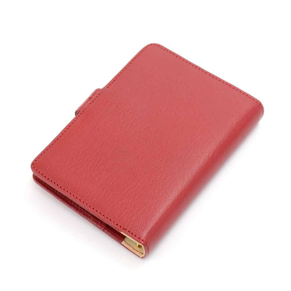 Chanel agenda in red leather. It has the classic Chanel gold-tone button on the front with a stud button closure. Inside has 3 slip pockets, a pen holder, and 6 gold-tone rings to hold your schedule, addresses, or notes. Refill papers can be bought
