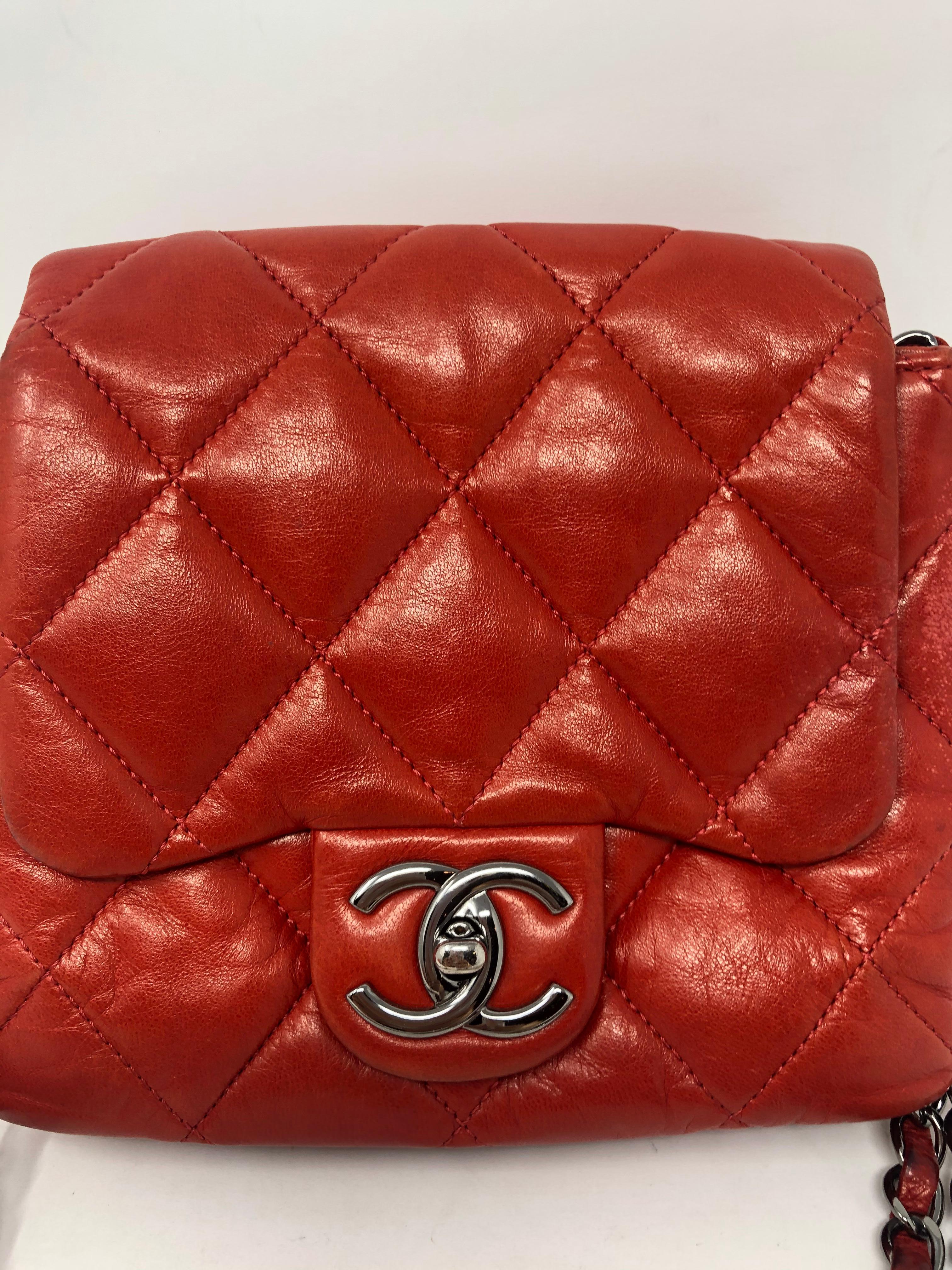 Chanel Red Square Shaped Leather Bag. Double strap leather chain can be worn crossbody. Soft red leather in fair condition. Has darkened in some spots from wear. Lots of life left. Slight rubbing on back. Please see photos. Not very noticeable. Mini