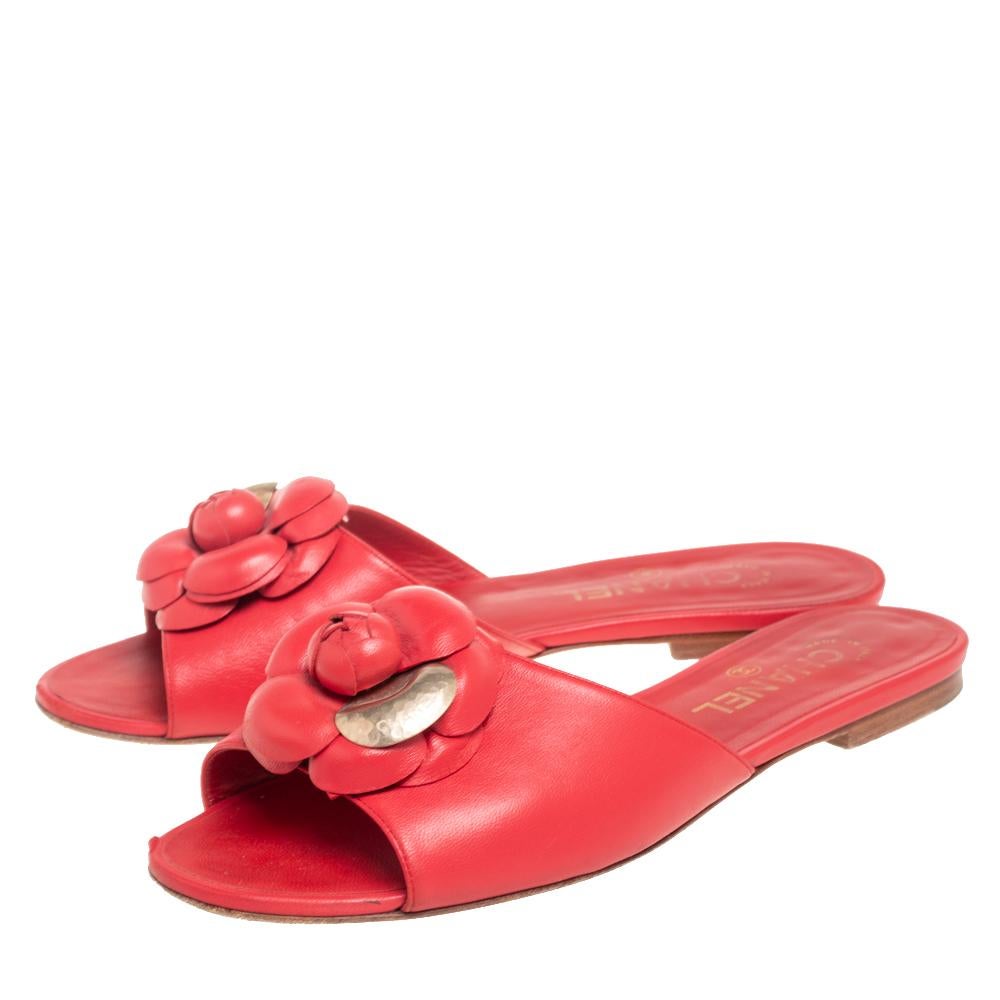 Walk with style and panache as you wear these flat sandals from the House of Chanel. They are designed using red leather on the exterior, with the signature Camellia motif adorning the front. They come with leather-lined insoles and a slip-on style.