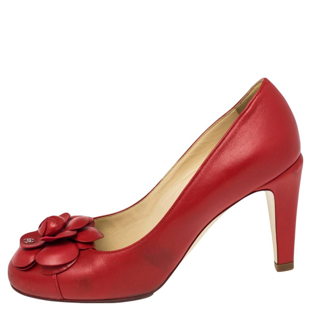 The dainty Camelia flower became synonymous with Chanel. This pair of pumps use the flower to create a casual yet elegant look. The exterior is made from red leather and has a single Chanel CC logo on the design. The interior has a leather lining