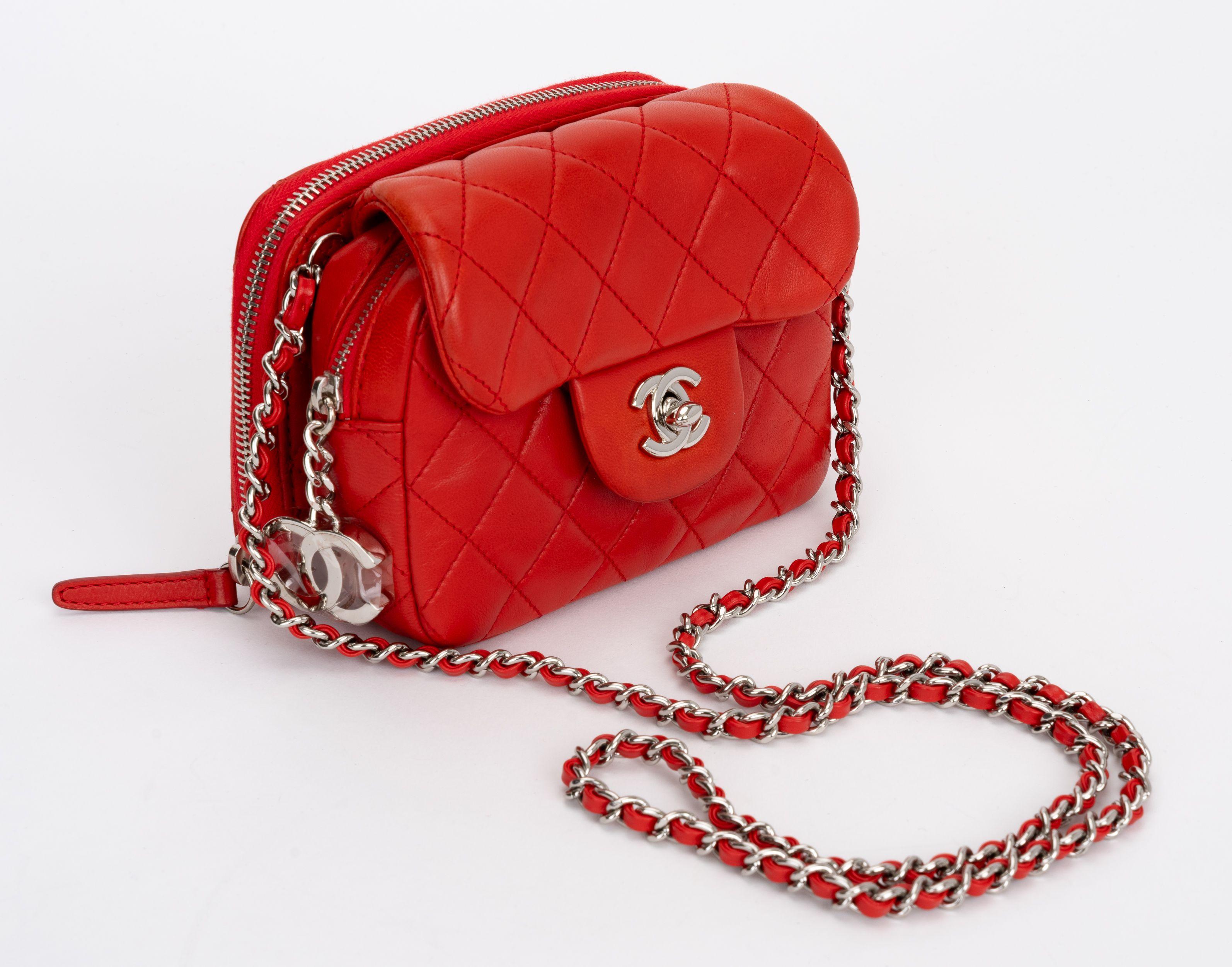 The Chanel red double sided crossbody in lambskin features an intertwined leather silver shoulder strap and a CC turn lock closure. The zipper wallet on back provides added space to your crossbody. 
Shoulder drop 19