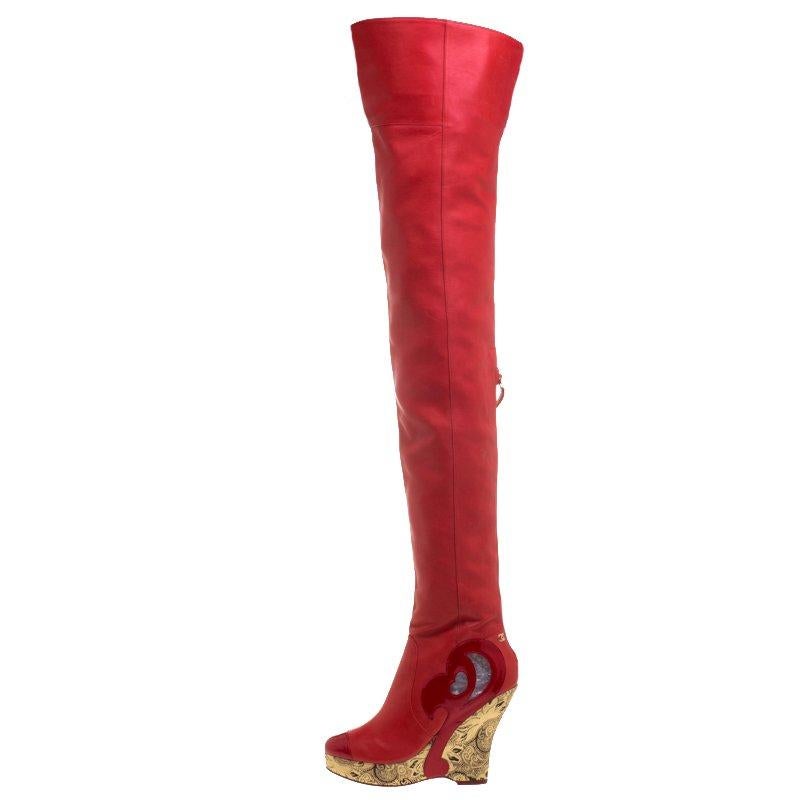 To complement your upbeat style, Chanel brings you these gorgeous thigh-high boots that come flowing with high-fashion. It is made from red leather and designed with cutouts and metallic gold wedges. Pair them with oversized sweaters and tunics to