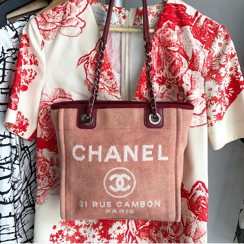 Chanel Red Mini Deauville Fabric Tote Bag.  Dark raspberry trim, silvertone double chain straps, magnetic clasp closure, intentionally distressed canvas fabric design.  Date code 15-series for production year 2011. Measures 10.25 x 10 x 4.5” with a