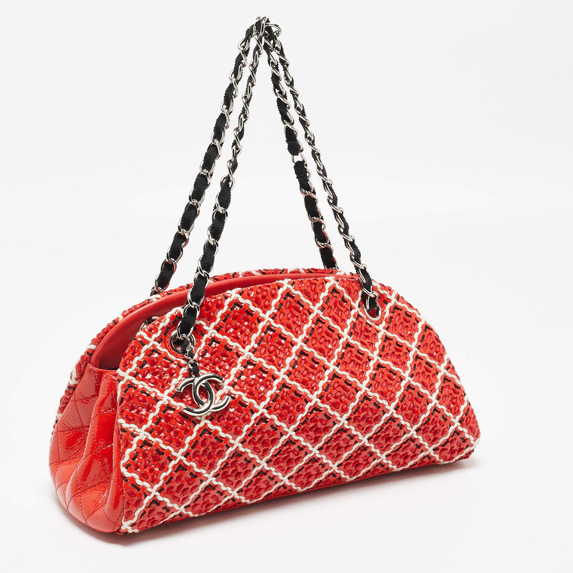 The Chanel Just Mademoiselle Bag is a sophisticated accessory featuring an iconic quilted pattern, vibrant red and multicolor hues, and exquisite patent leather. With meticulous stitching and a medium size, it epitomizes timeless elegance and modern