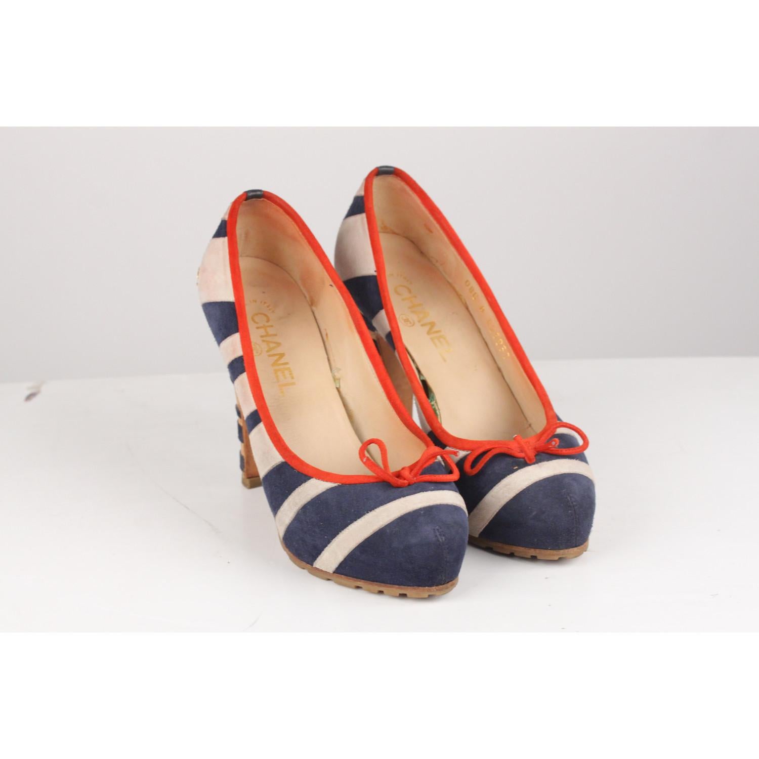 - CHANEL Suede Striped Pumps in Navy, White and red colors 
- Gold CC logo embellishment on the heel
- Red suede leather piping  and bow on  the toe
- Cork heels with Navy blue suede leather stripes
- Heels height: 4.5 inches - 11,5 cm 
- Rubber