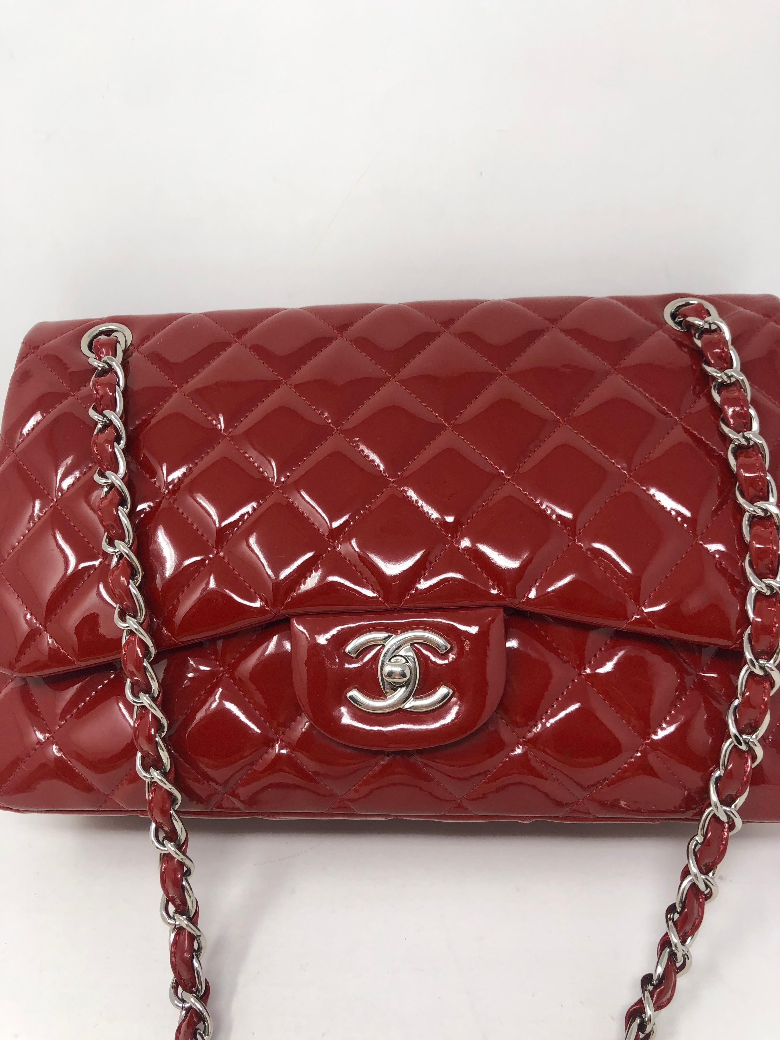 Chanel Red Jumbo Patent Leather Bag. Double flap silver hardware. Cherry red color. Good condition. Can be worn crossbody and doubled as a shoulder bag. Includes authenticity card. Guaranteed authentic. 