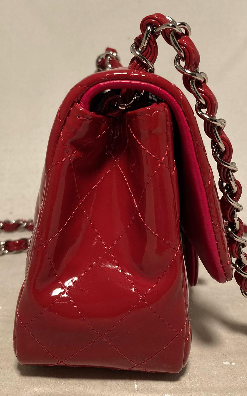 Chanel Red Patent Leather Mini Classic Flap in very good condition. Red quilted patent leather exterior trimmed with silver hardware. Front CC logo twist closure opens via single flap to a matching red leather interior that holds one slit and one