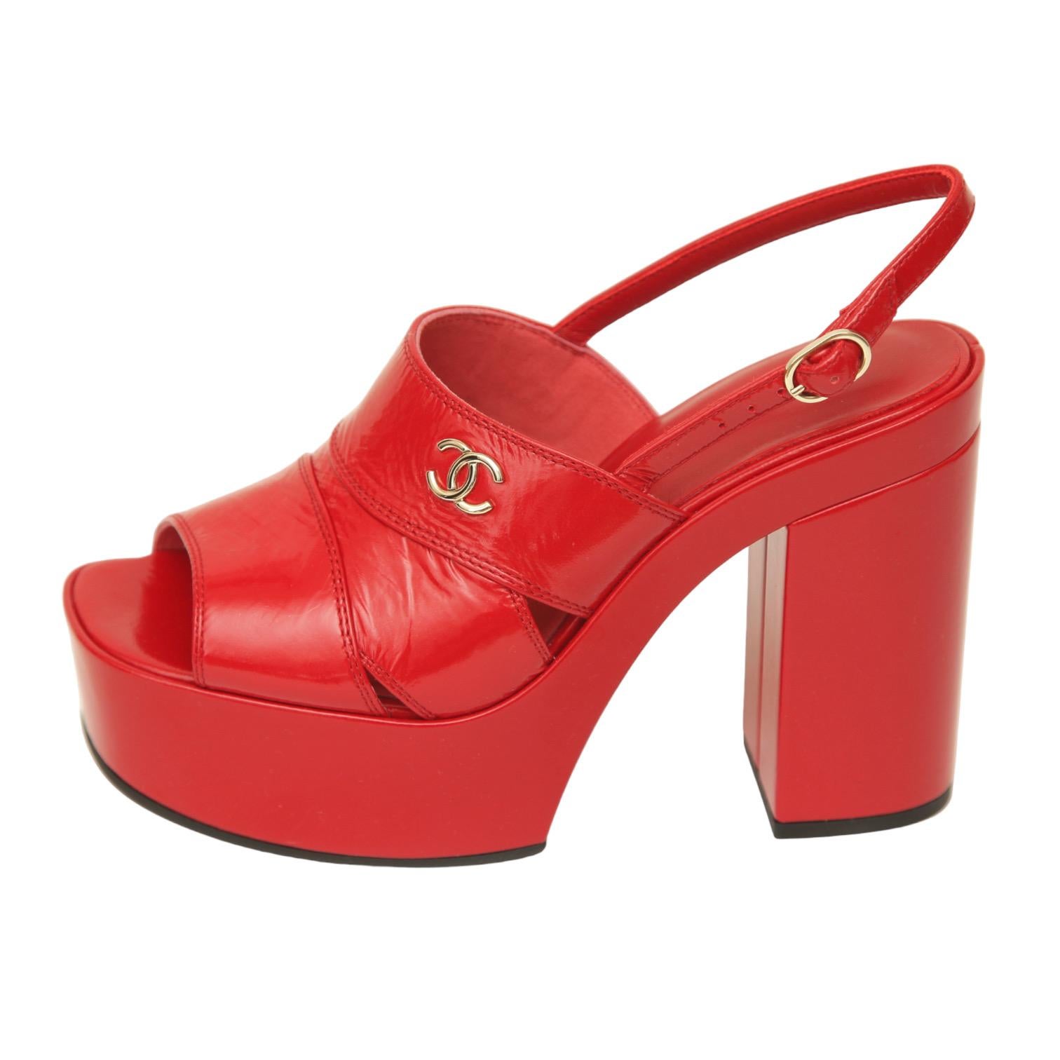 GUARANTEED AUTHENTIC CHANEL RUNWAY 2023 METIERS D'ART RED PATENT LEATHER PLATFORM SANDALS

Design:
- Red patent leather uppers.
- Red patent leather platforms and heels.
- Gold-tone CC metal logo.
- Buckle closure.
- Leather insole.
- Comes with