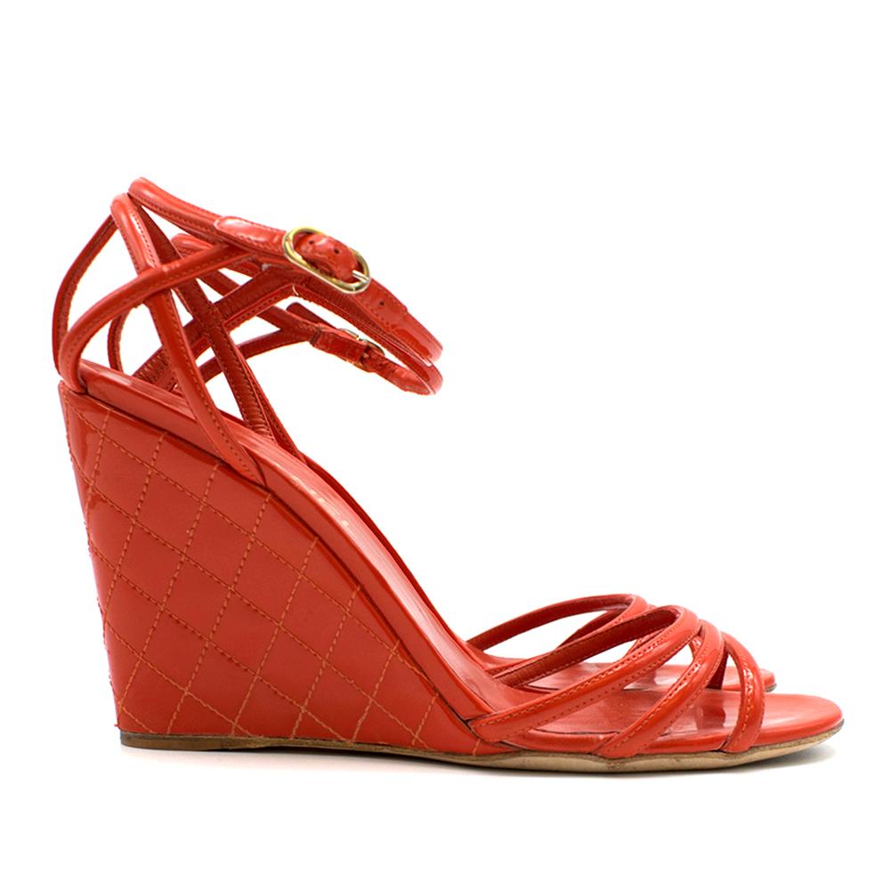 Chanel Red Patent Leather Logo Peep-toe Wedge Sandals

Red patent leather
Peep-toe wedge sandals
Tonal stitching
Silver-tone CC accents at counters, 
Covered heels
Buckle closures at ankles
Strap detailing
Includes box.
Dust bag included

Please