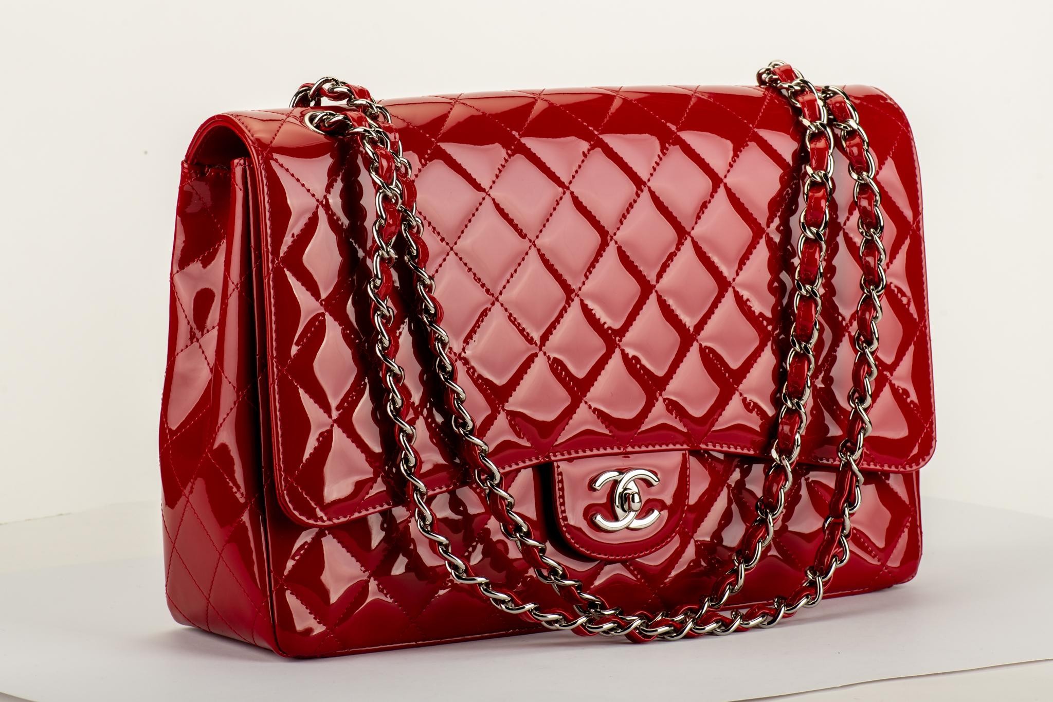 Chanel mint condition red patent leather maxi flap with silver tone hardware. Shoulder drop 11
