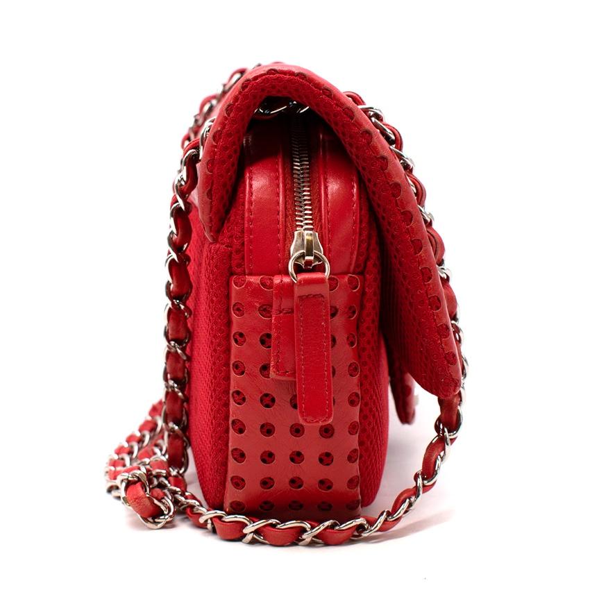 Chanel Red Perforated Leather & Airtex CC Logo Flap Bag
 

 - Bright red hue
 - Perforated leather flap, contrasted with a Airtex mesh body
 - Silver-tone metal hardware
 - Chain strap 
 - Zip under flap
 - Black grosgrain lined
 

 Materials 
 100%