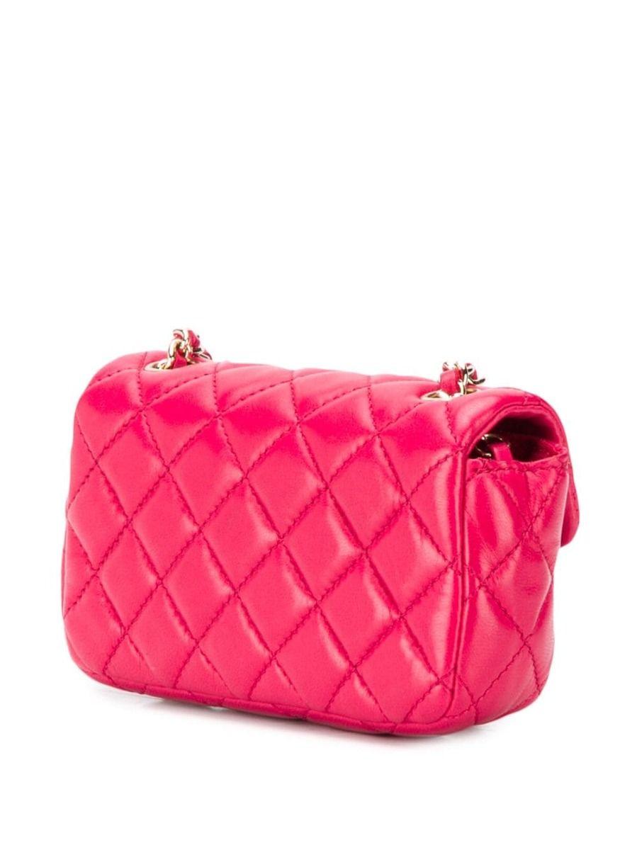 Crafted in Italy from lipstick red lambskin leather, this limited edition mini cross-body bag from Chanel's Riviera-inspired cruise 2011 collection is irresistibly playful in its design and features the iconic diamond quilted design, interlocking CC