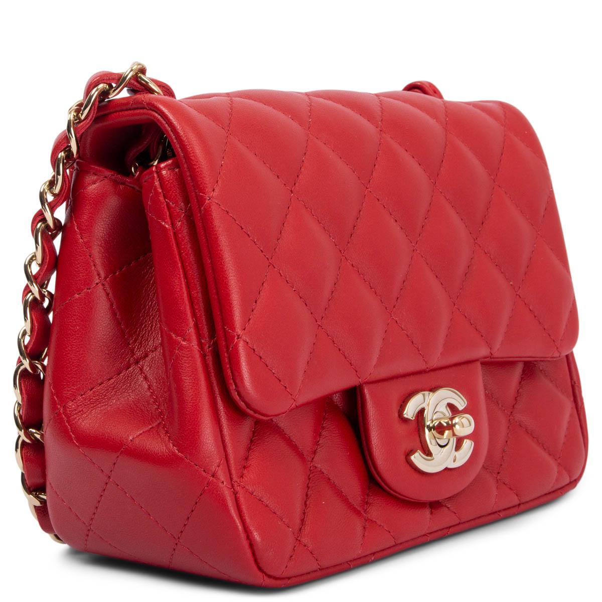 100% authentic Chanel mini square flap shoulder bag in red quilted lambskin leather with silver-tone hardware. Open pocket on the outside back. Closes with classic double CC turn-lock. Lined in leather with an open and zipper pocket against the