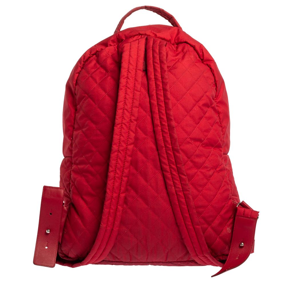 This lightweight and sporty backpack by Chanel has signature quilting and the CC logo. The red nylon bag features zip fastening, front pocket and a spacious interior. It is complete with a top handle and shoulder straps.

Includes:Pouch