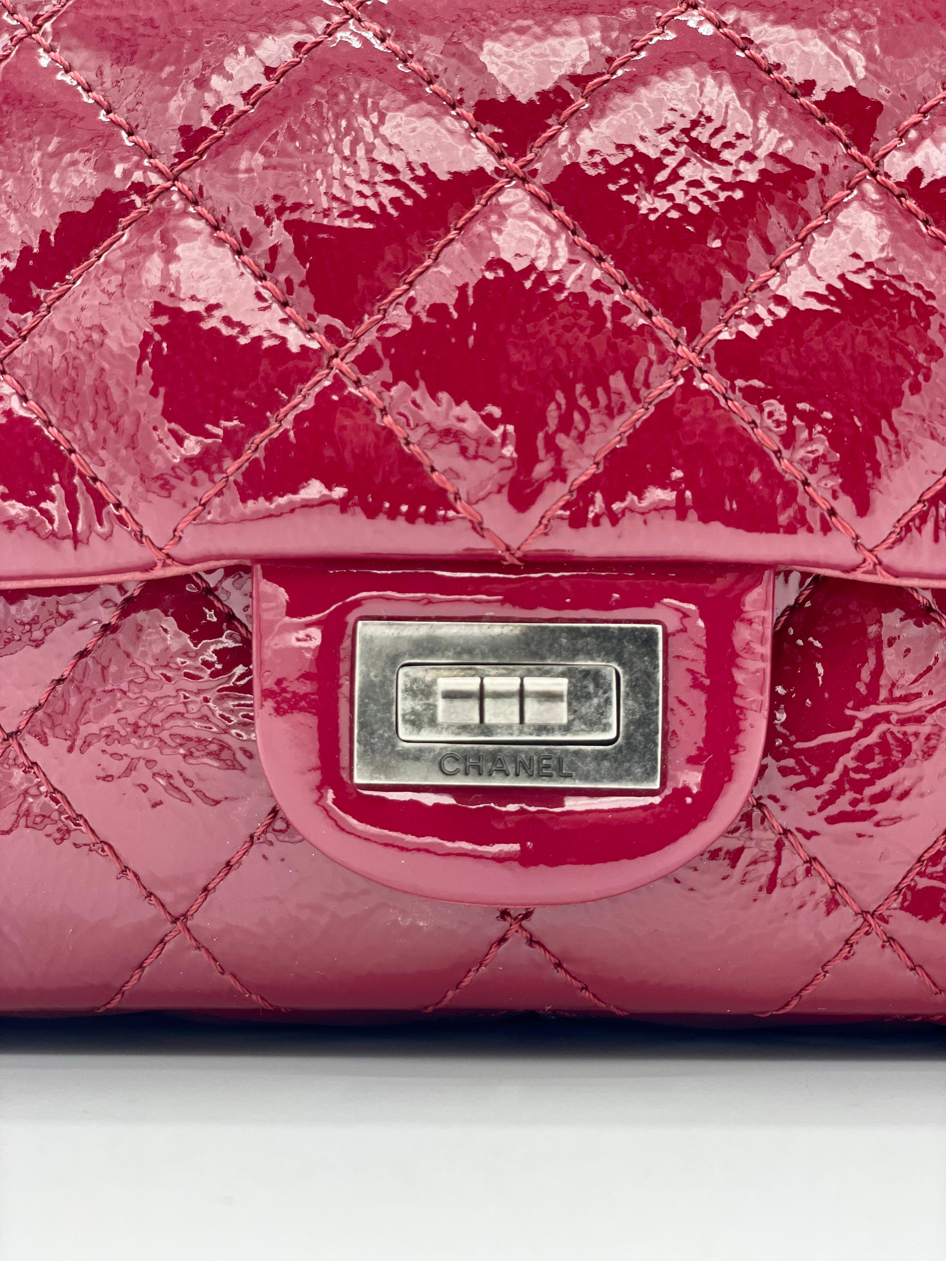 2010-2011 Chanel Patent Leather Quilted Red 2.55 Reissue 225. Red patent leather with quilting, encircled by silver hardware. 
It also includes Coco Chanel's Mademoiselle Lock. The two flaps open to reveal a grey leather-lined inside with a 