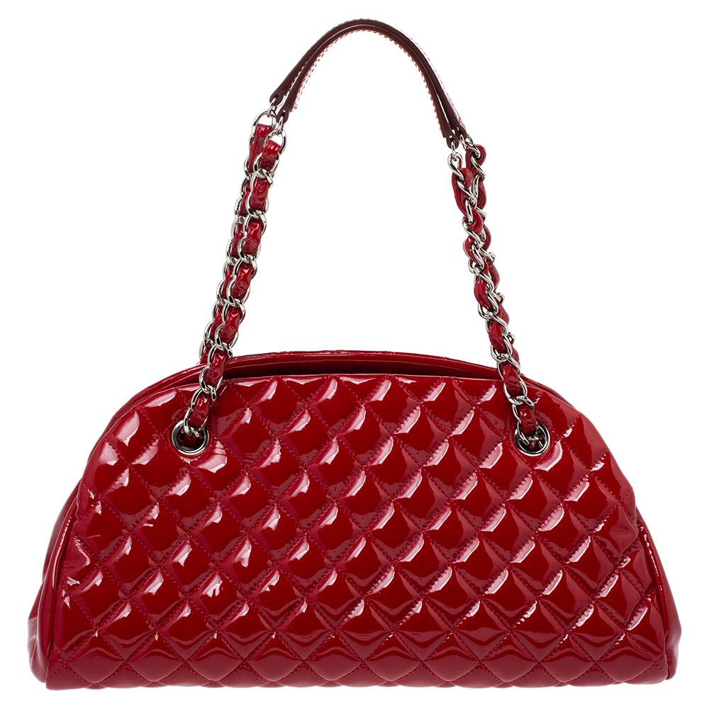 Spacious and captivating, this Just Mademoiselle Bowler bag is from Chanel. It has been crafted from quilted patent leather and features a lovely shape and design. It is equipped with two chain handles and well-sized canvas compartments to keep your