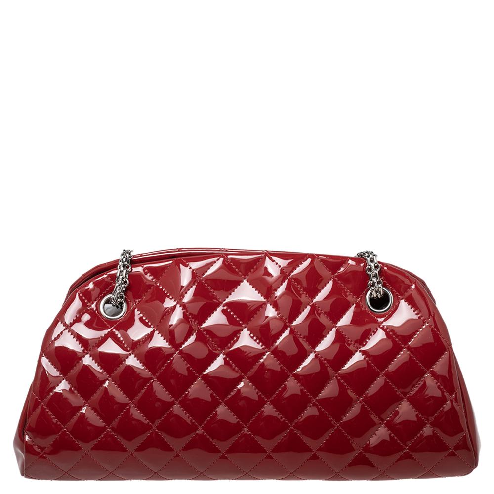 Spacious and lovely, this Just Mademoiselle Bowler bag is from Chanel. It comes crafted from red patent leather, covered in the signature diamond quilt, and enhanced with silver-tone hardware. It is equipped with chain handles and a canvas
